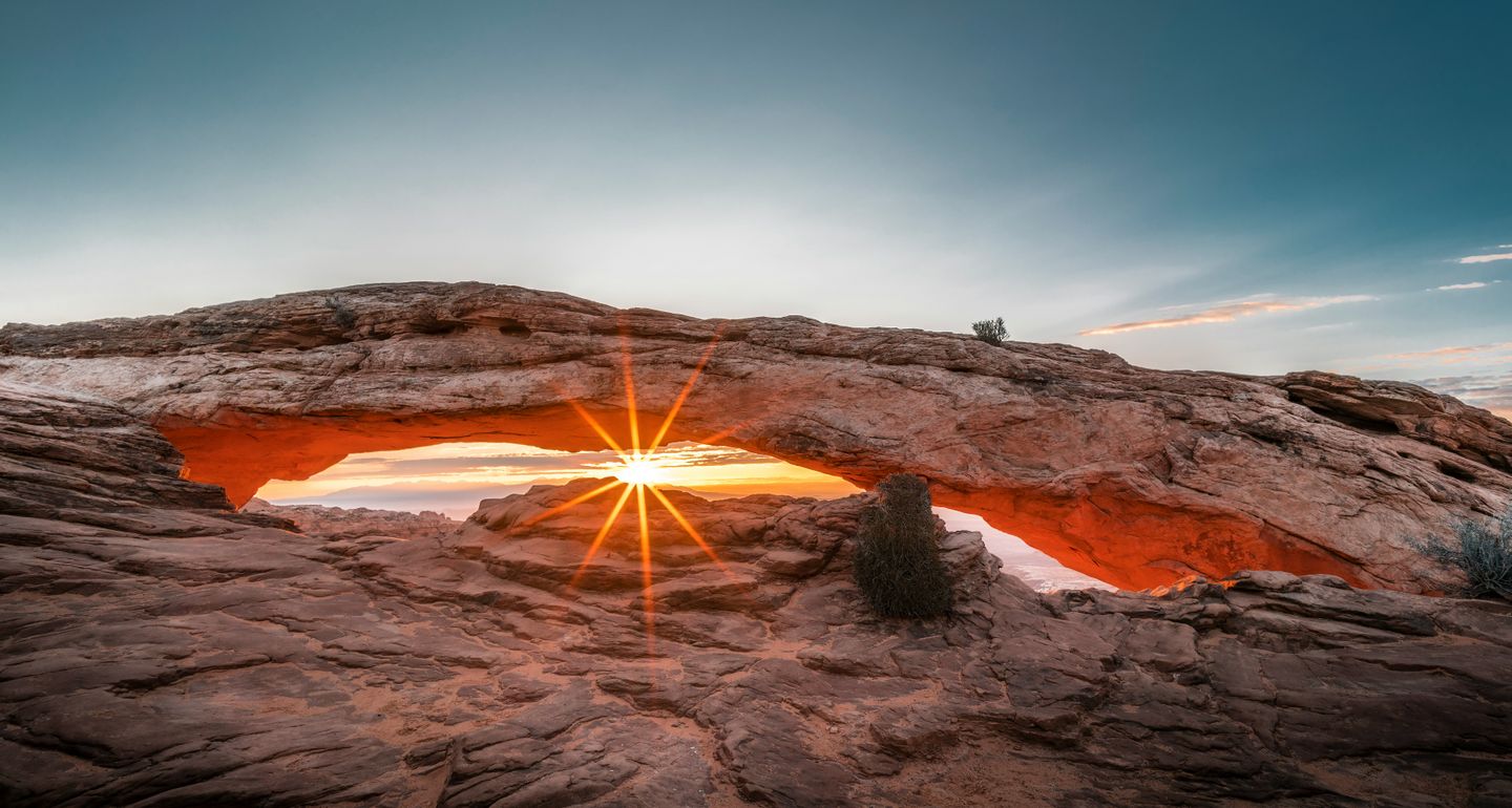 A rock formation shaped like an arch Mesa Arch Trail, Moab, United States