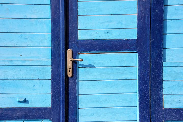 a blue door slams shut