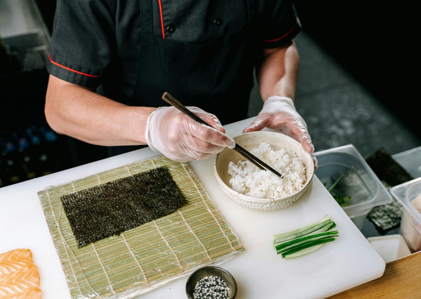 A chef prepares sushi rolls