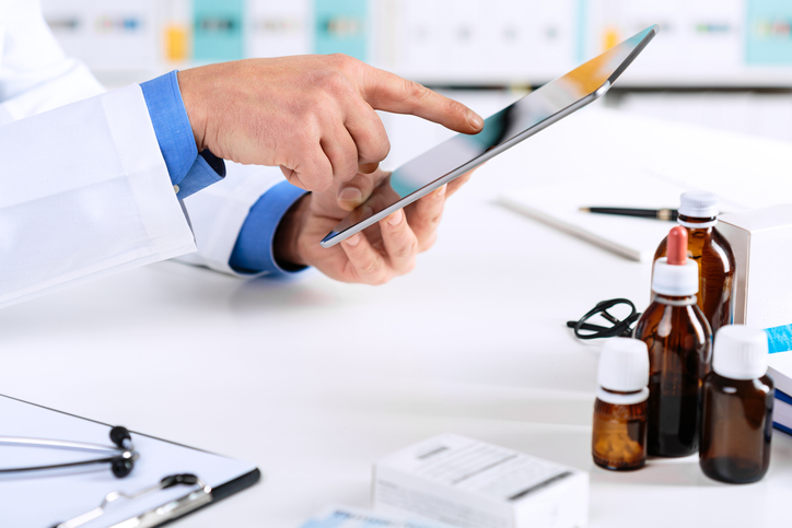 healthcare provider working on tablet.