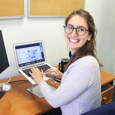 julia working on laptop smiling