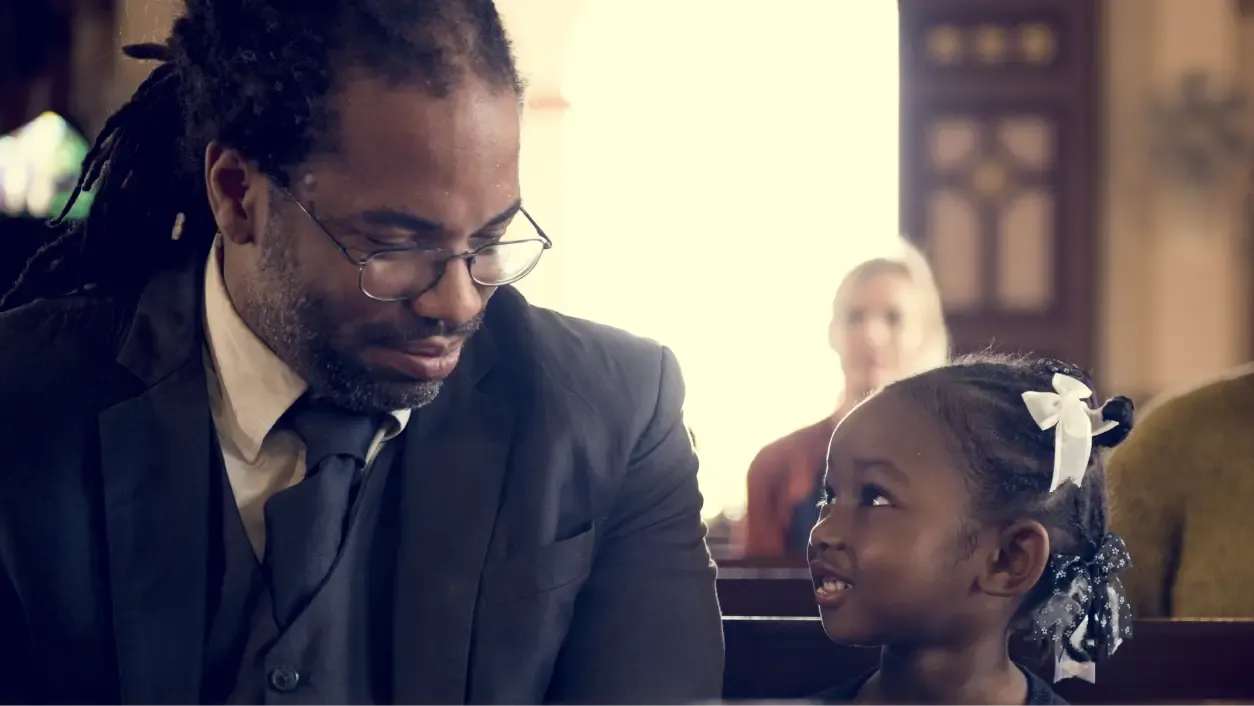 Father and daughter sitting in church