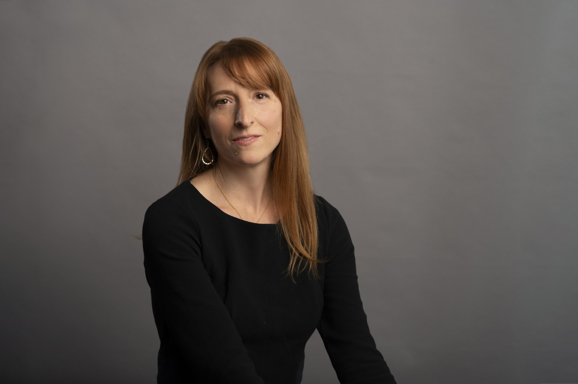 Woman with red hair and black shirt