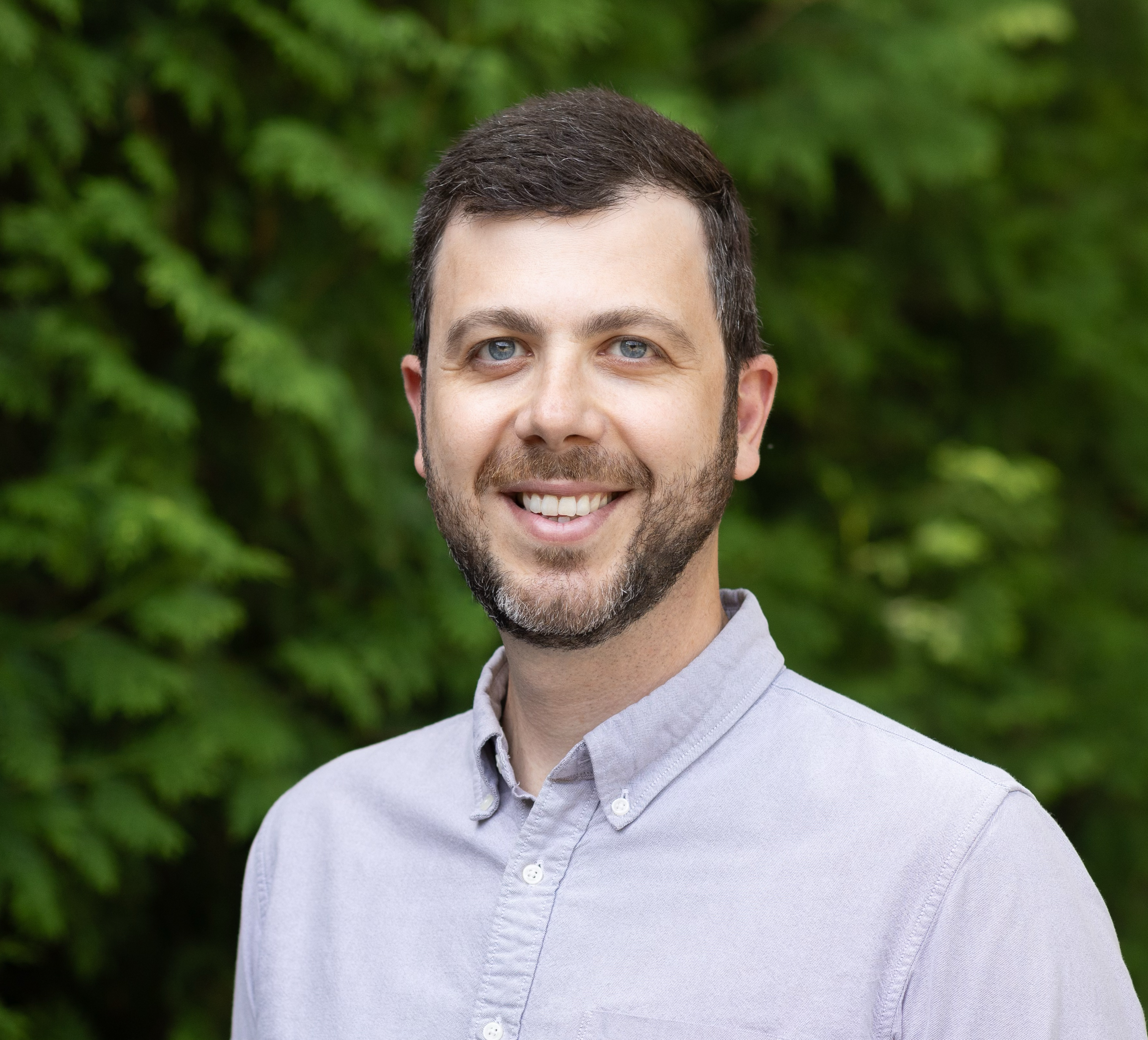 image of man with brown hair in button down shirt