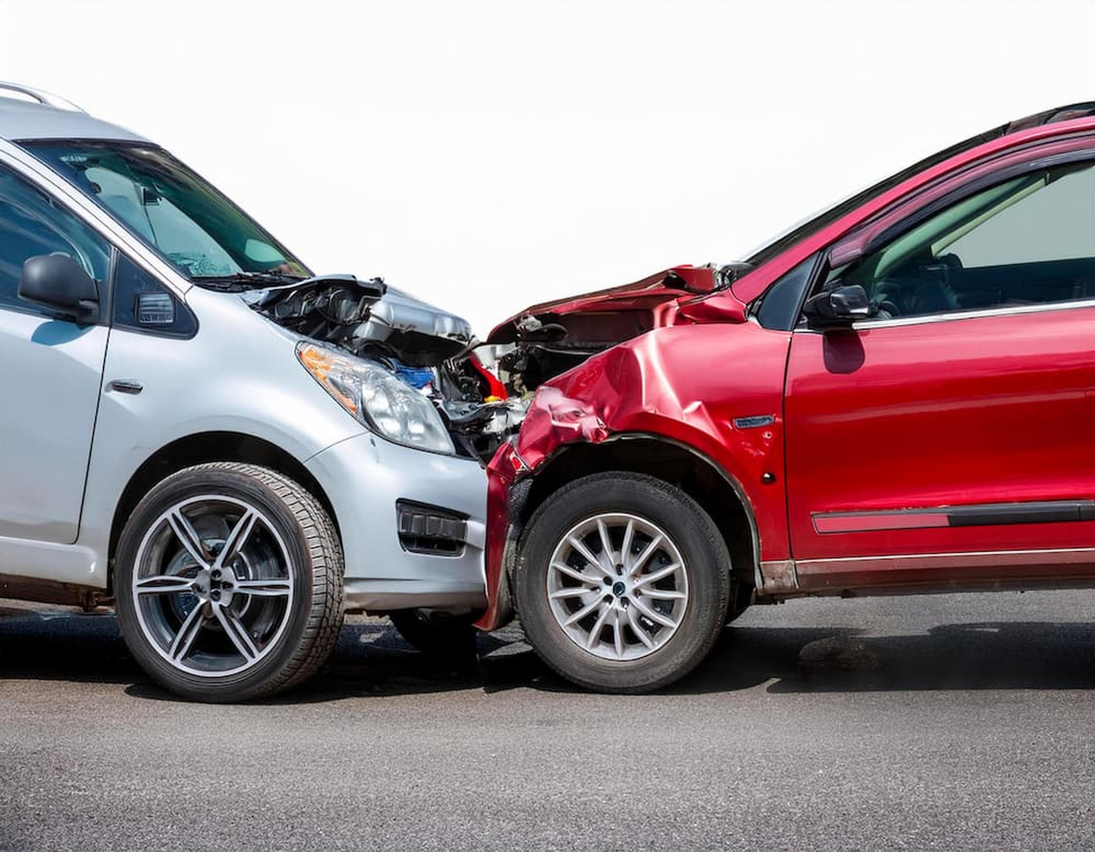 A head-on collision between a silver and a red car, illustrating the complex liability issues handled by a self-driving car accident lawyer.