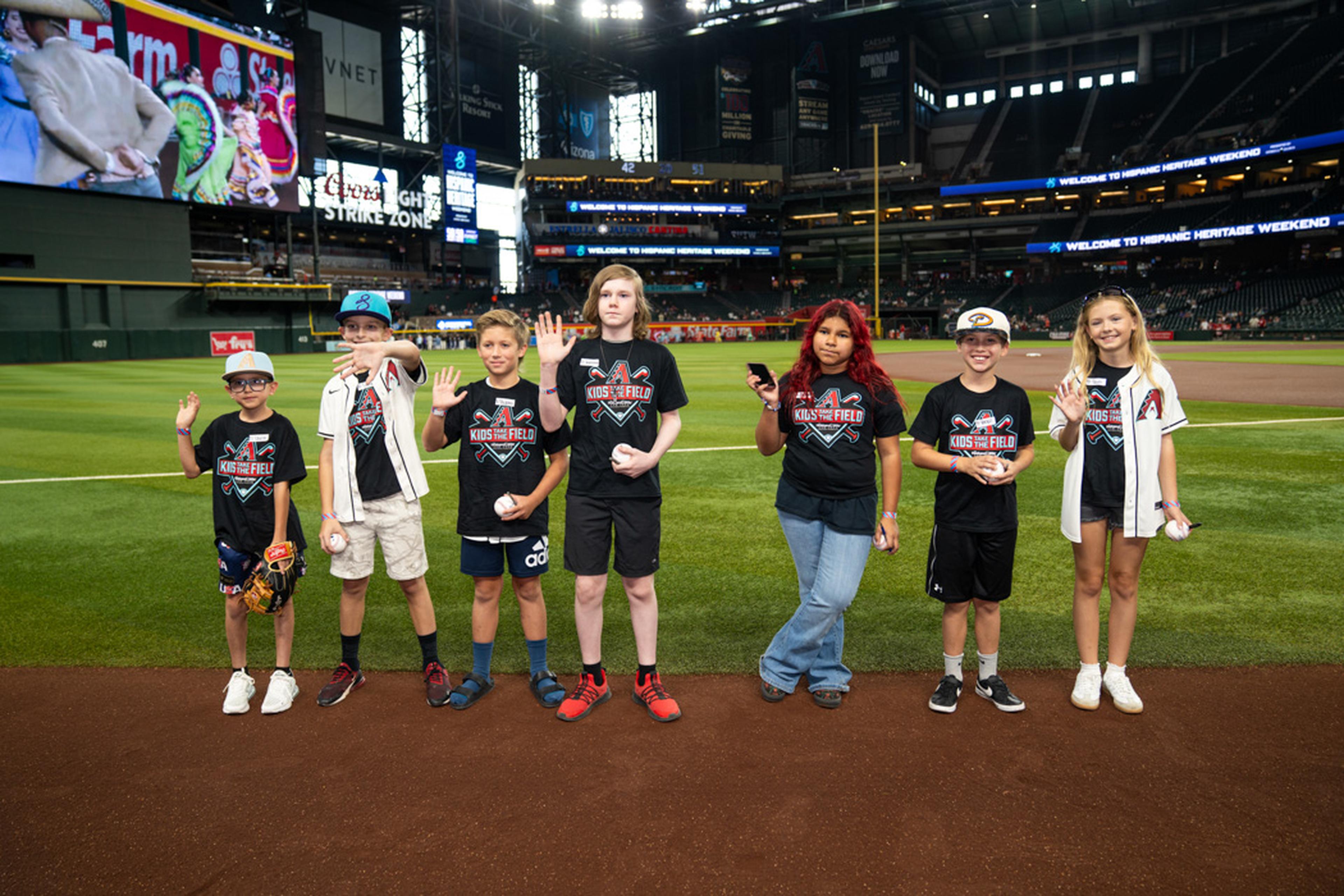 Excitement filled the air as Kids Take the Field participants smiled, waved, and took in the thrill of standing on Chase Field before the game.