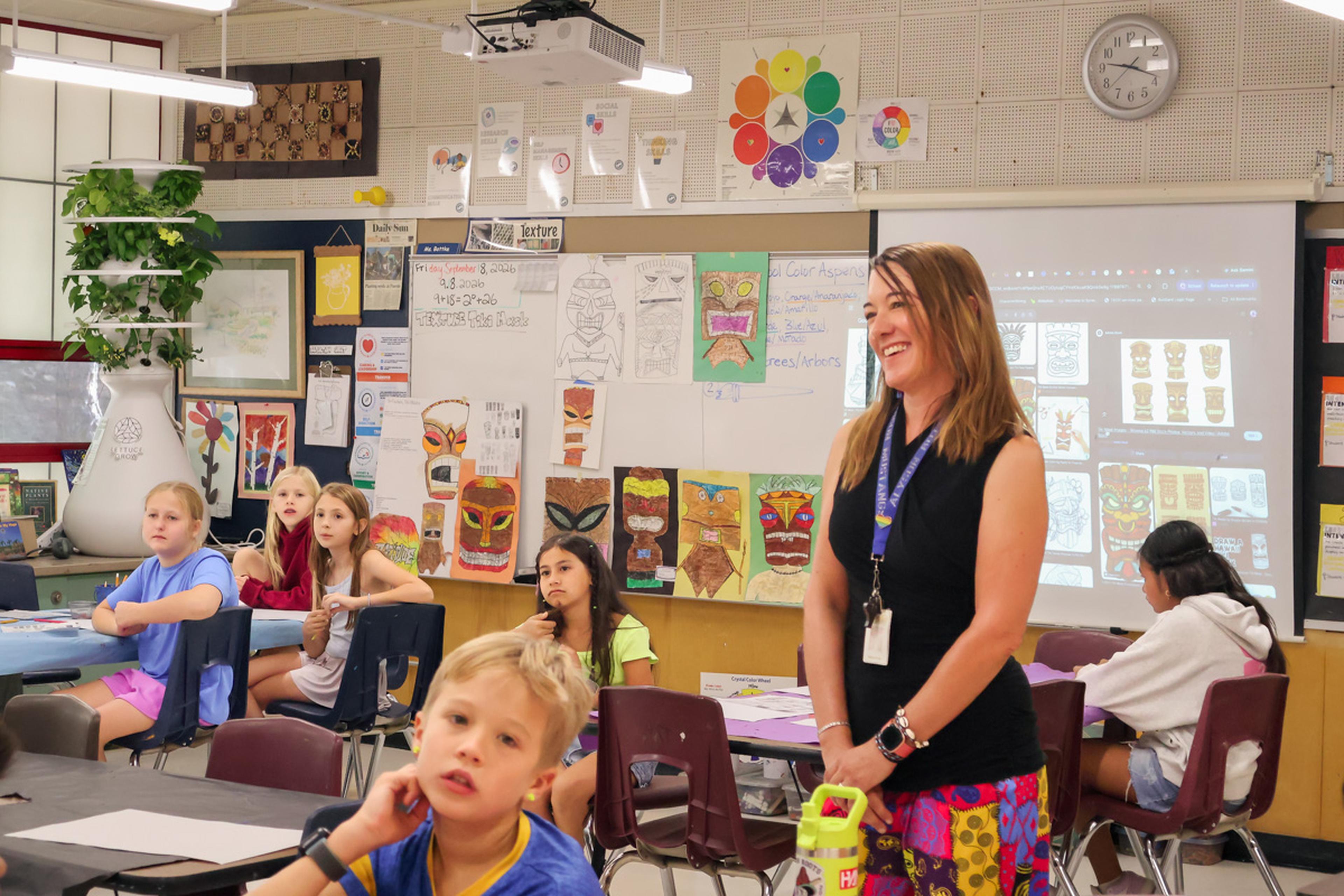 Ms. Bottke smiles in her classroom at Puente de Hózhó Elementary, fostering creativity, engagement, and a love of learning for her students each day.