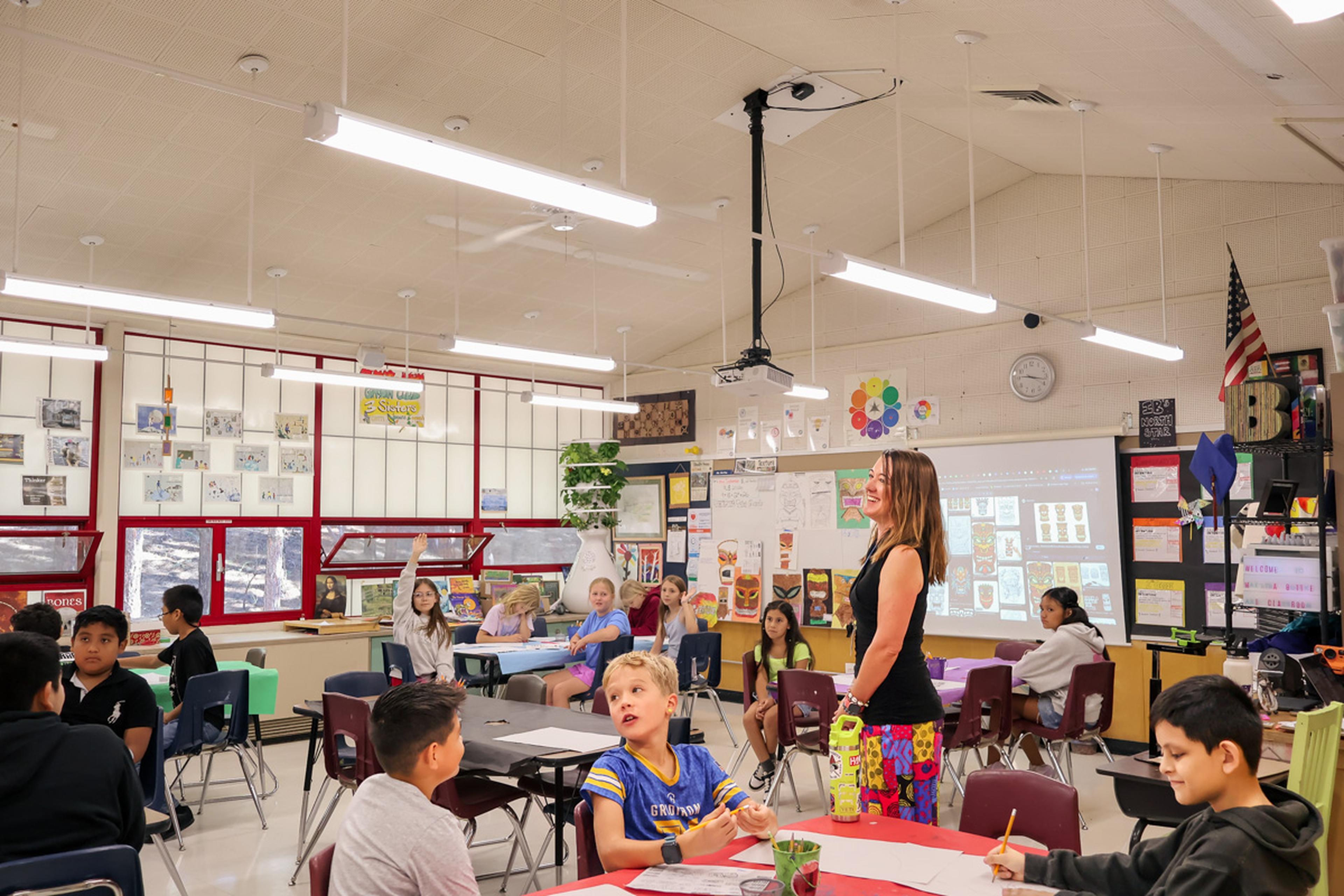 Ms. Bottke smiles at the front of her classroom at Puente de Hózhó Elementary, engaging students and fostering a positive learning environment where every child is encouraged to participate.