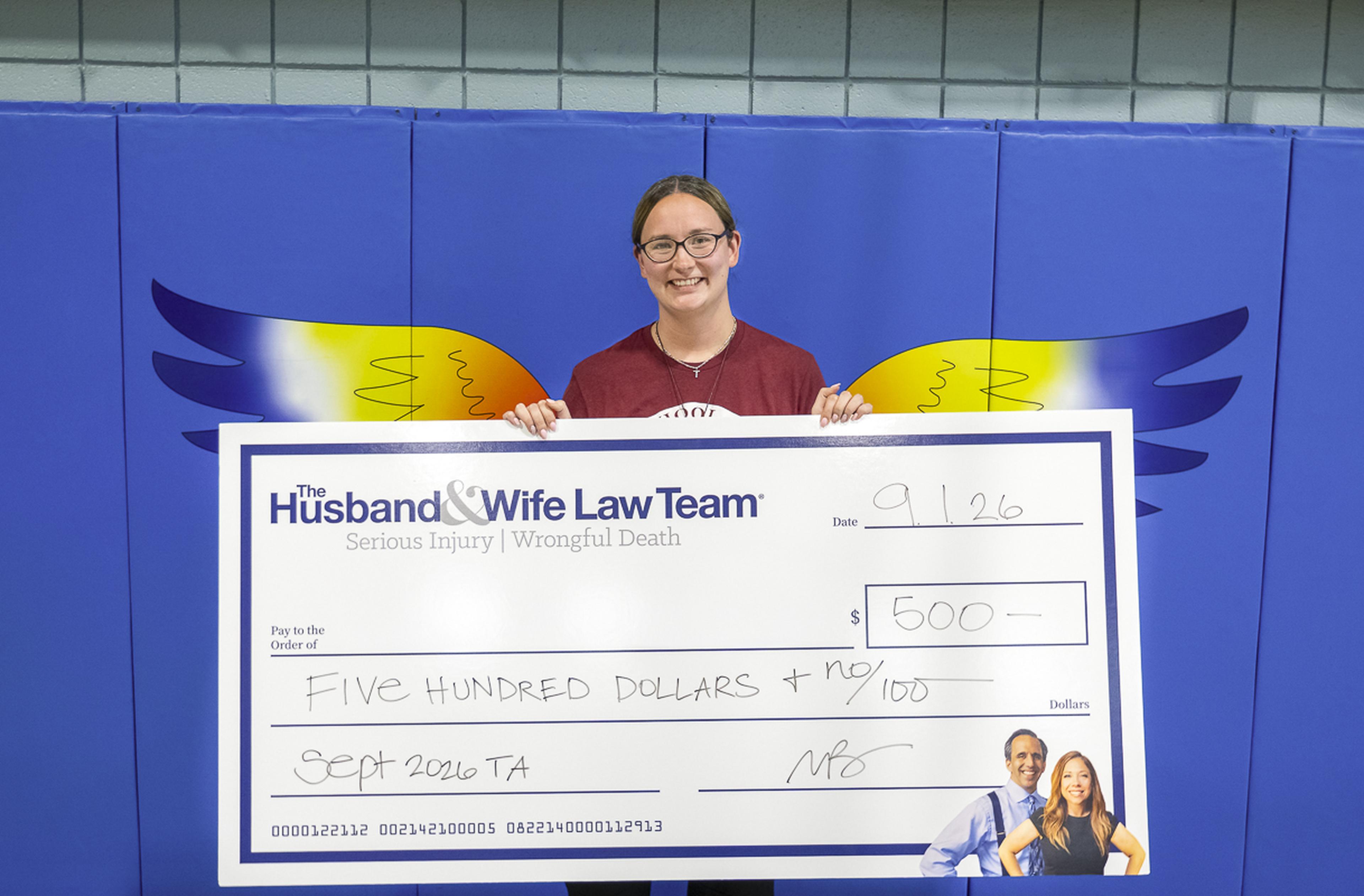 Ms. Quintana proudly displays her $500 Teacher Appreciation Award from the Husband & Wife Law Team, recognizing her dedication and positive impact on students at Chaparral Elementary School.