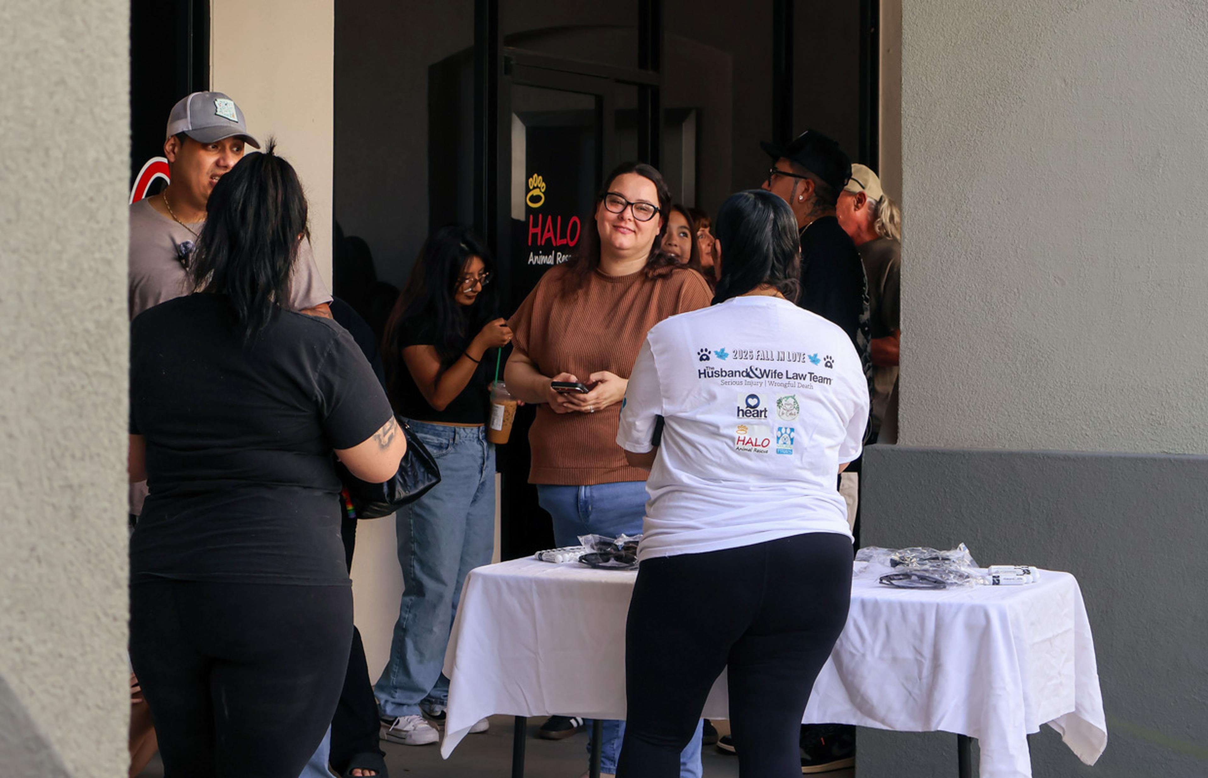 A lively crowd connects outside HALO Animal Rescue as the Husband & Wife Law Team’s HALO Adoption Event brings together animal lovers, volunteers, and families in support of pet adoption.