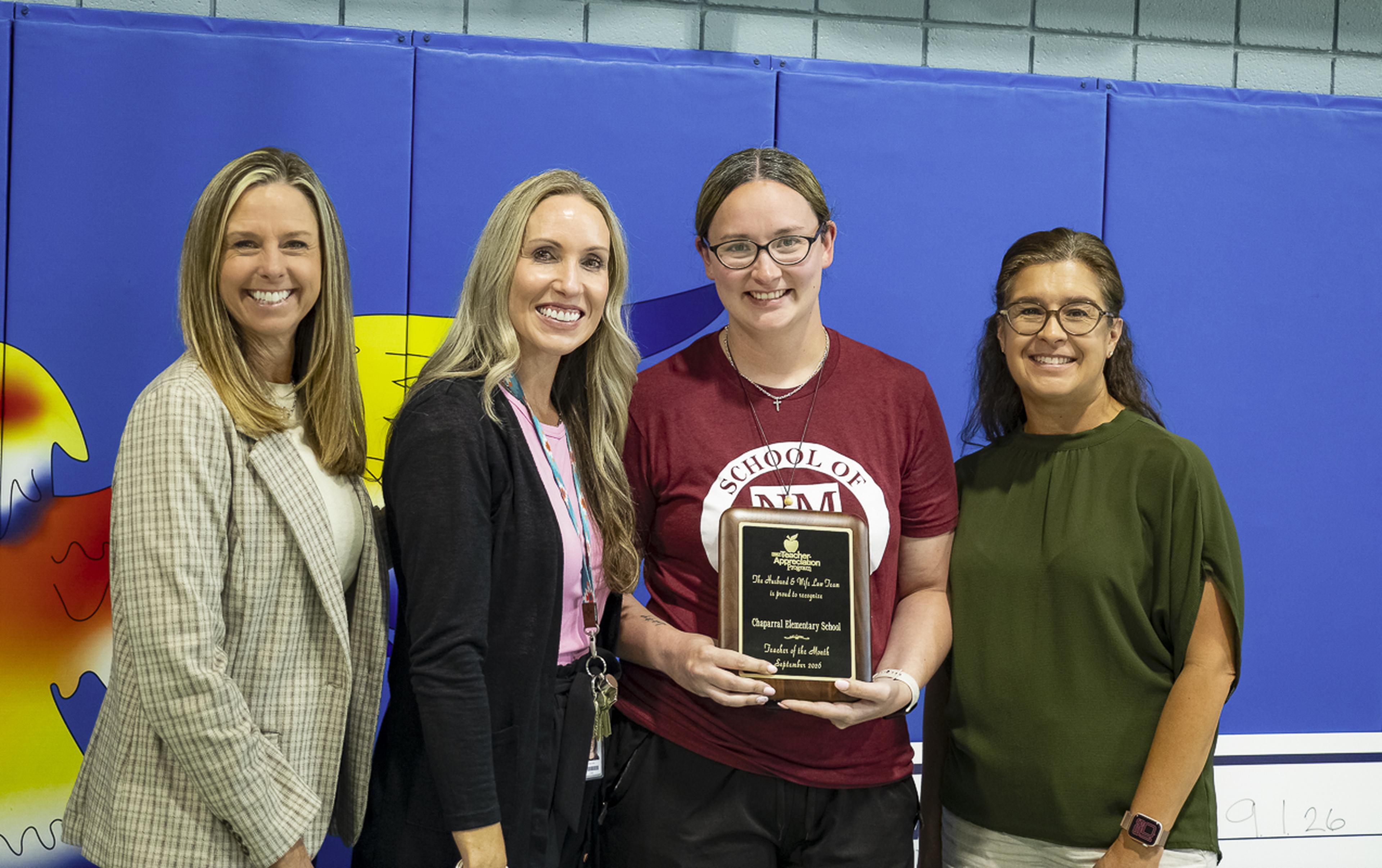 School staff gather to celebrate Ms. Quintana’s Teacher Appreciation Award, recognizing her dedication, leadership, and positive impact on students and colleagues.
