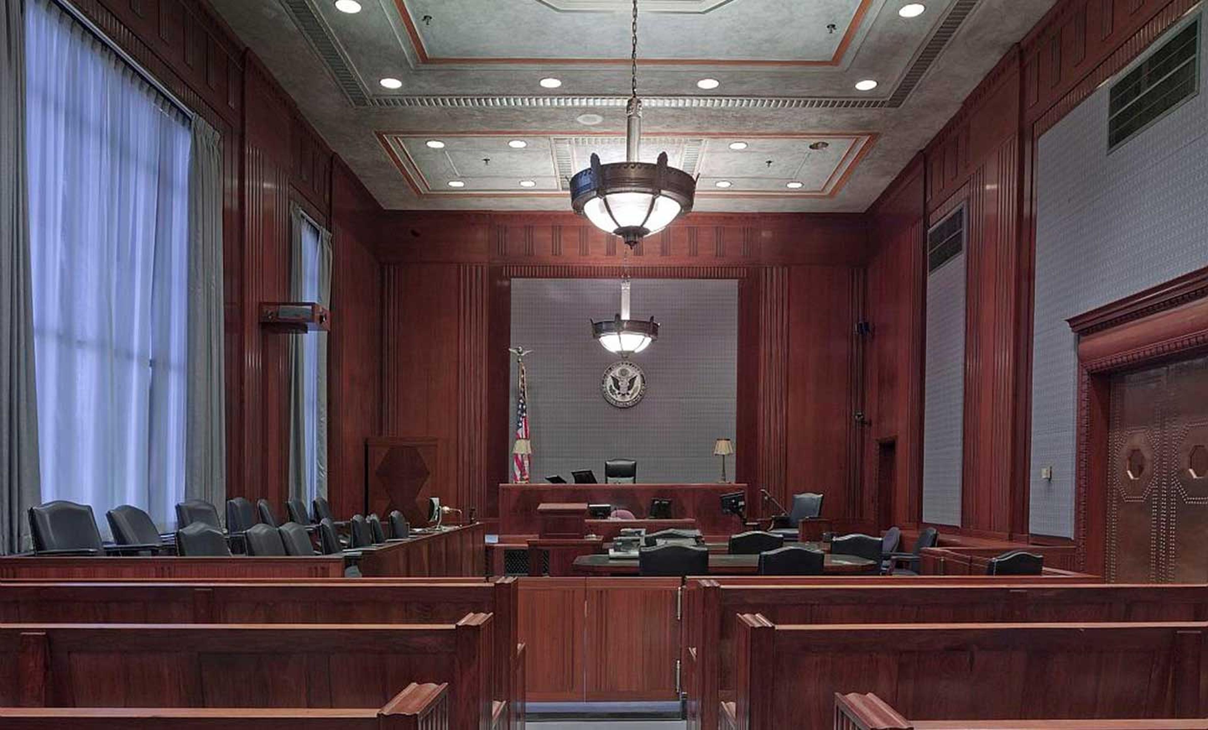 A courtroom with the American flag in the left corner