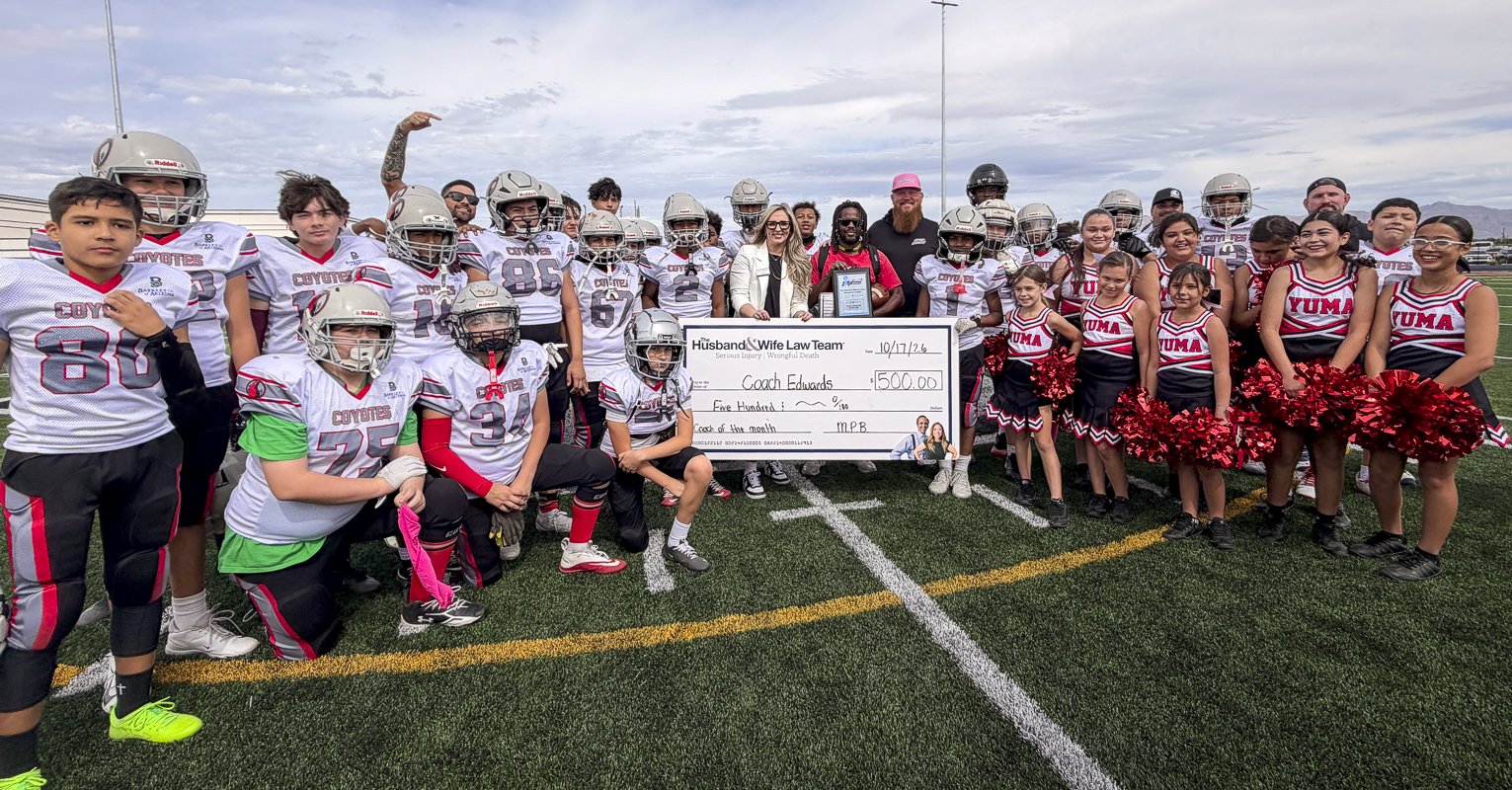 A winning moment on and off the field! Young athletes and cheerleaders come together to celebrate Coach Edwards as the Husband & Wife Law Team’s Coach of the Month.