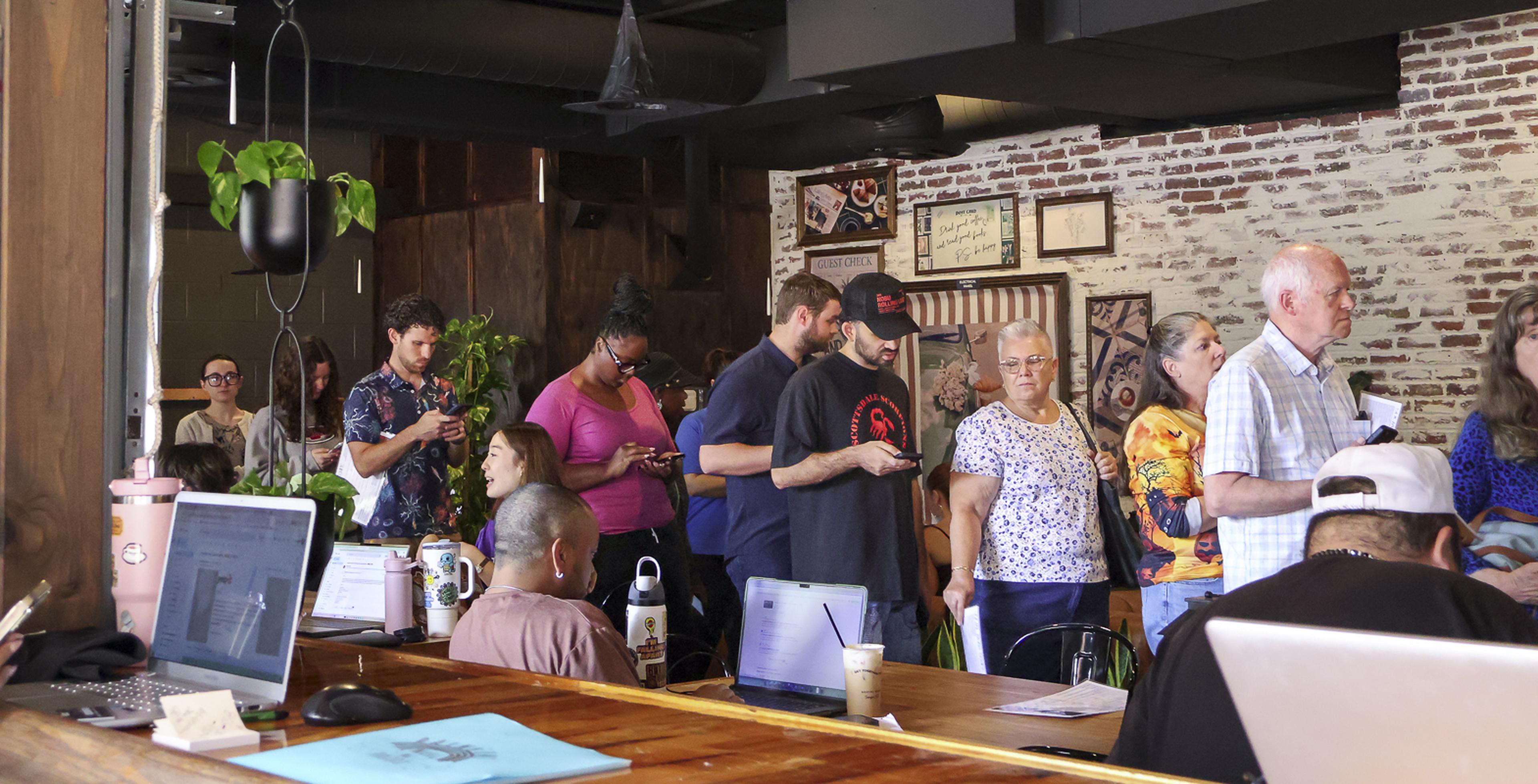A busy line at Social Bean Café & Bakery shows the great turnout for the Husband & Wife Law Team’s afternoon coffee event.