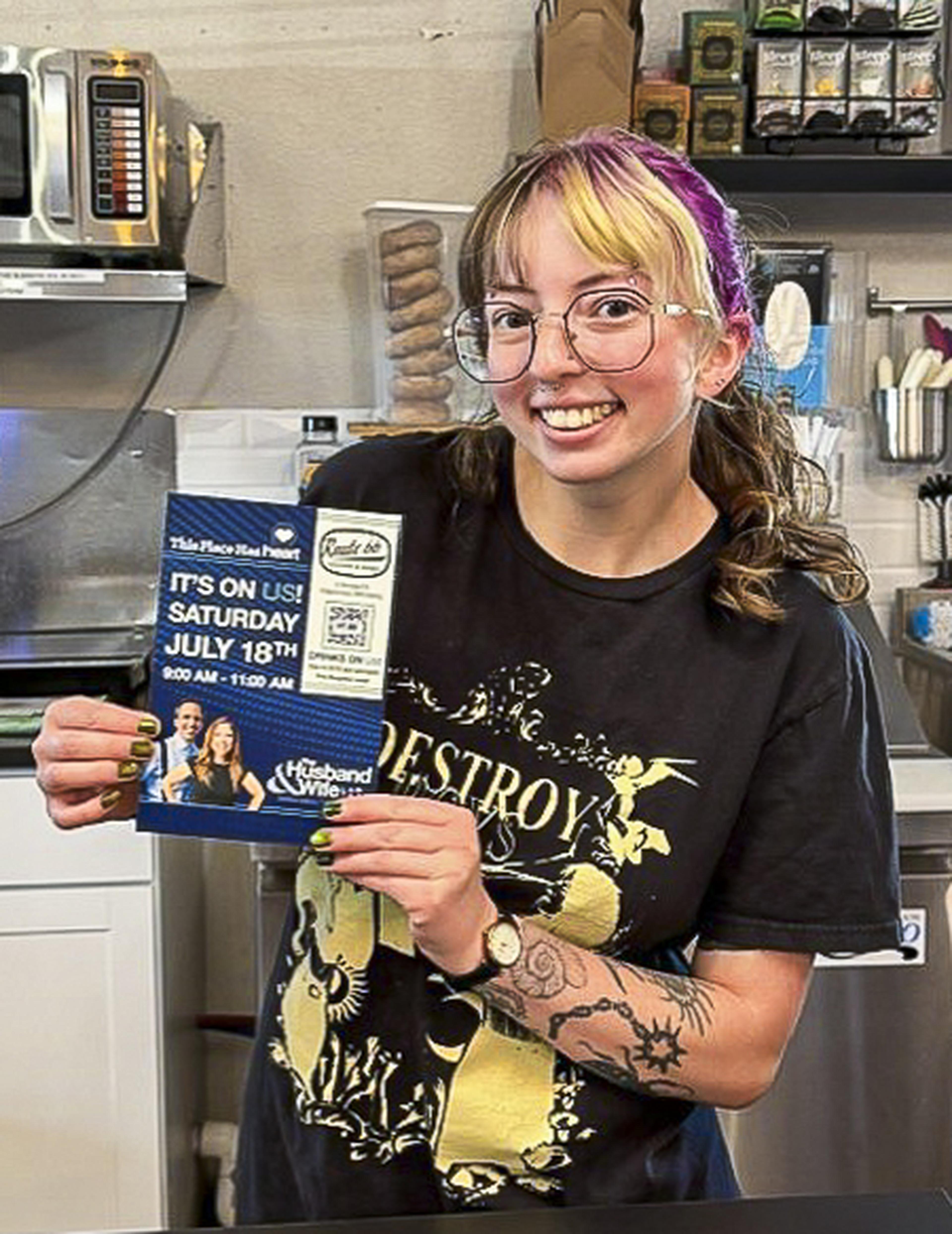 A friendly team member helps spread the word about the upcoming HEART event on July 18, proudly displaying a Husband & Wife Law Team flyer.