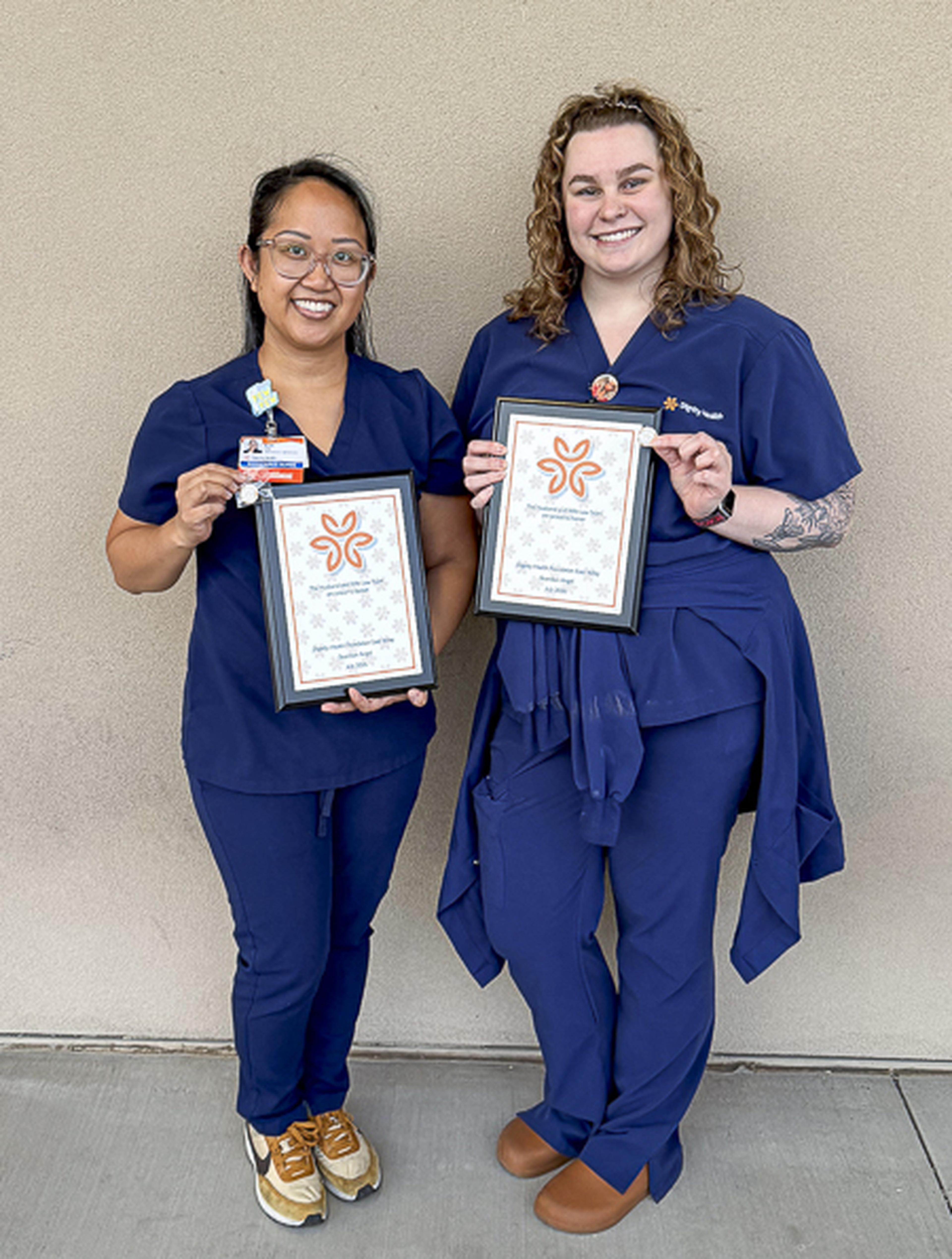 Nurses Marissa and Audi proudly display their Guardian Angel Awards, recognizing their dedication, compassion, and commitment to exceptional patient care.