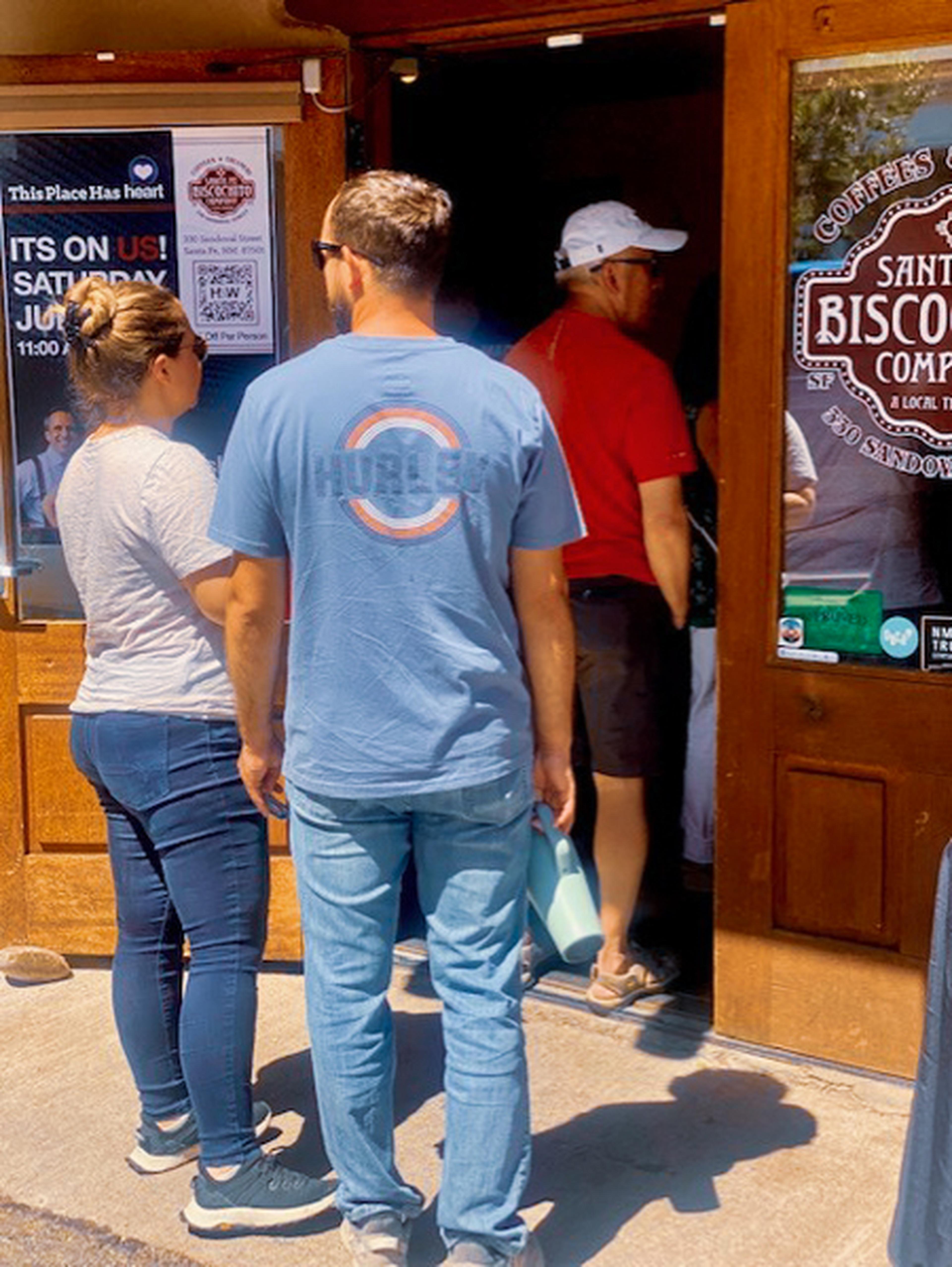 People waiting in line for cookies on The Husband & Wife Law Team at Santa Fe Biscochito