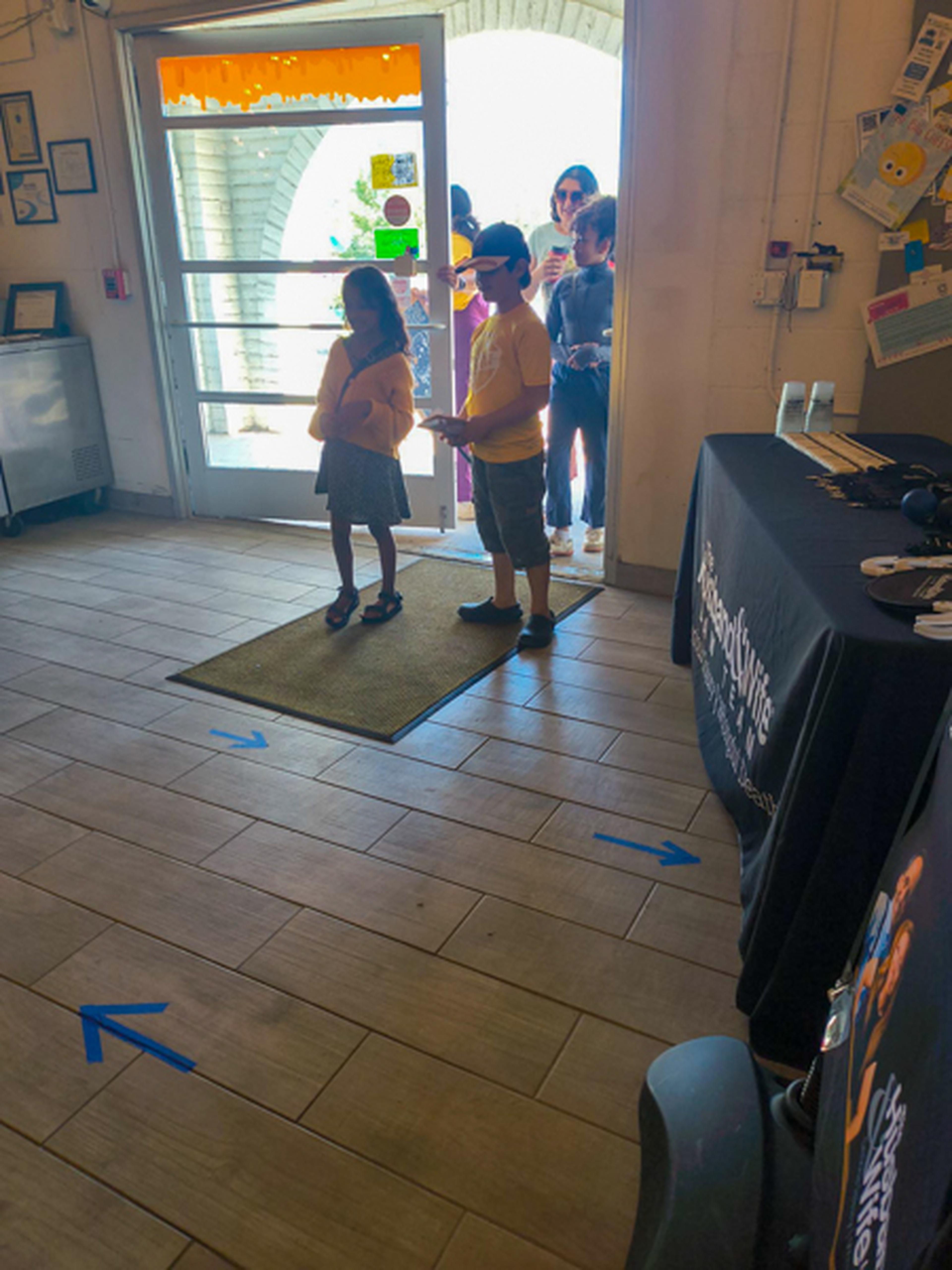 Kids and adults at the entrance of the event awaiting its start