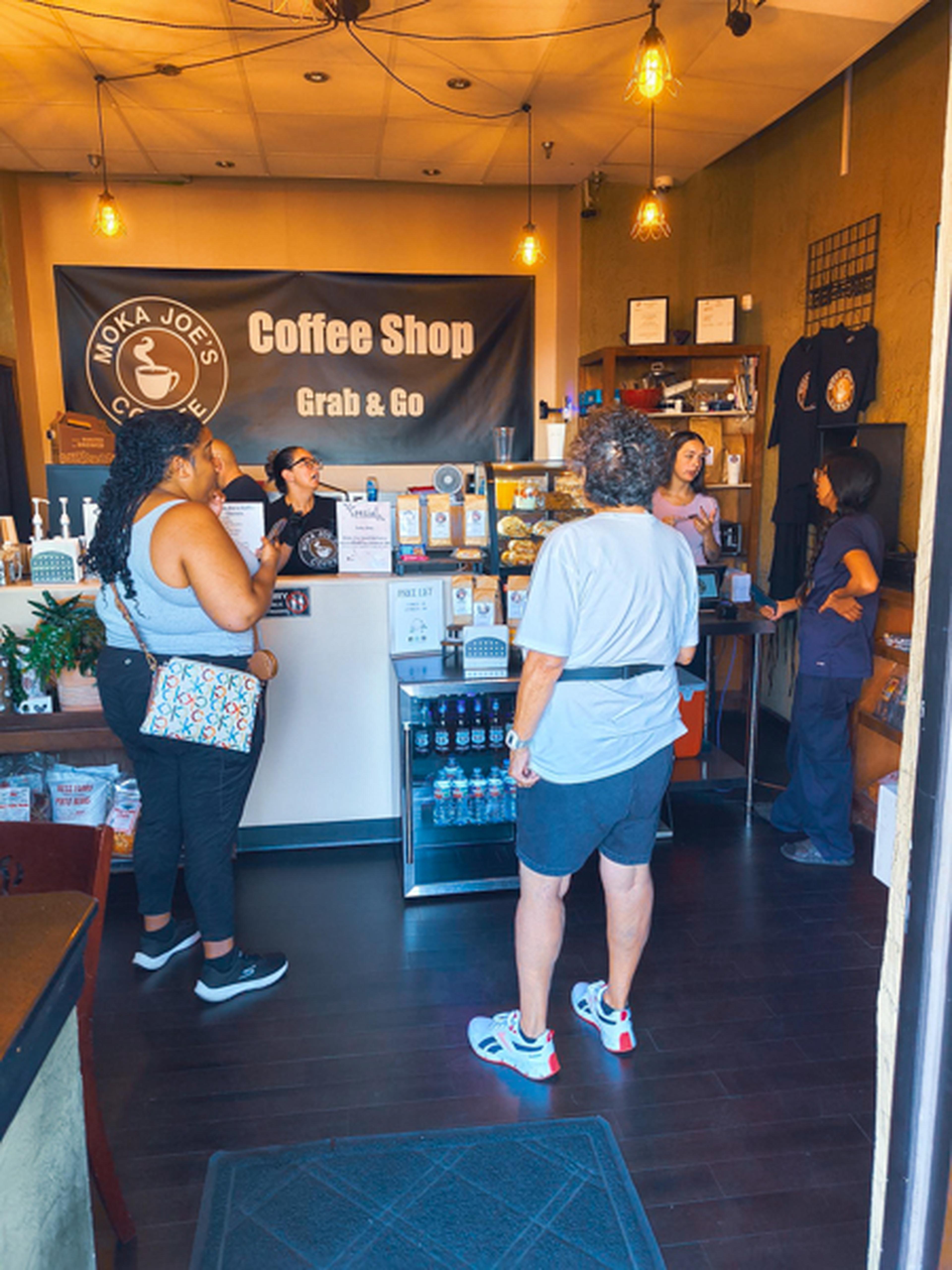 Three customers and two employees at Moka Joe's Coffee Shop