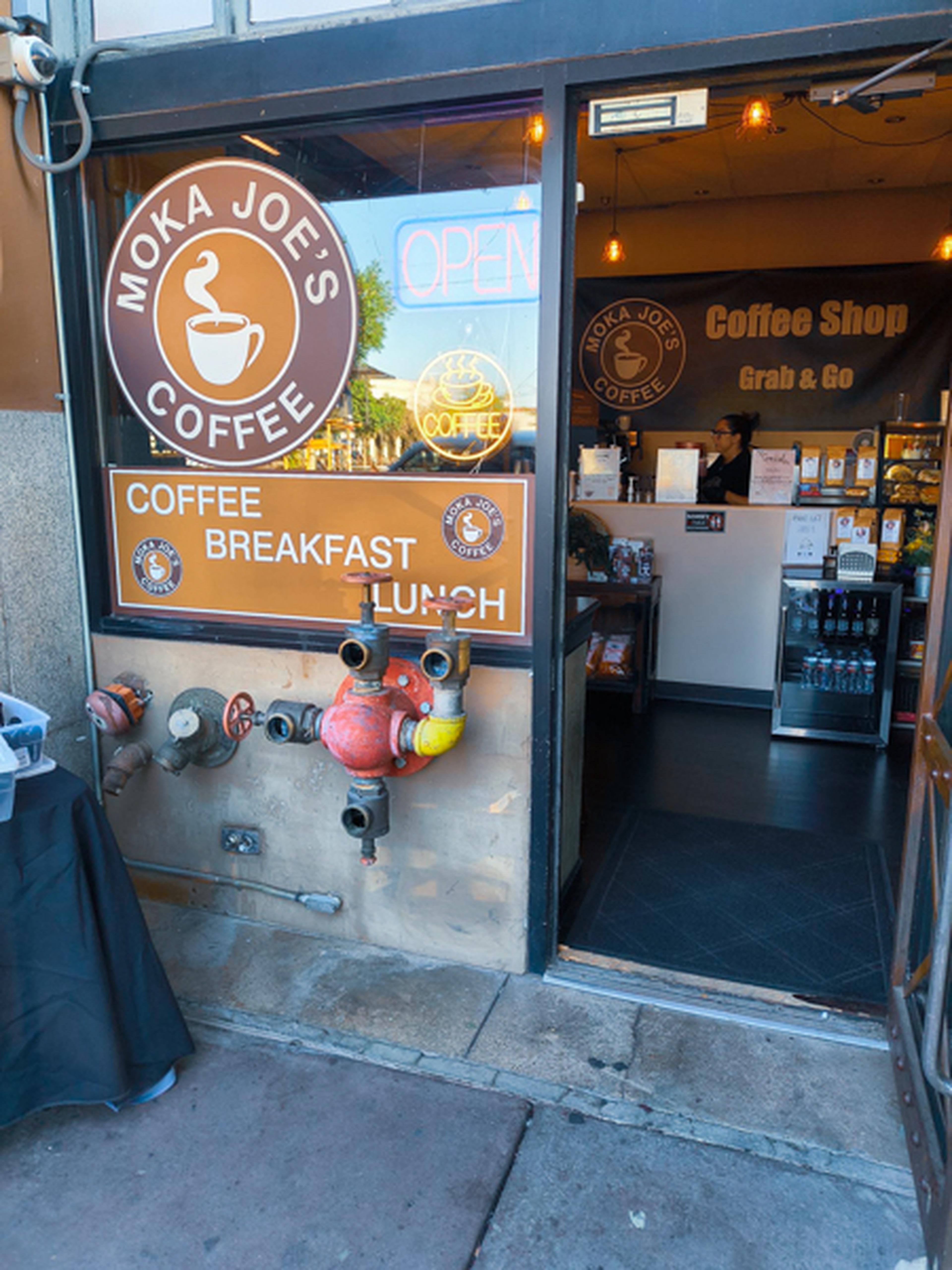 The front of Moka Joe's Coffee with the front door open and a view inside
