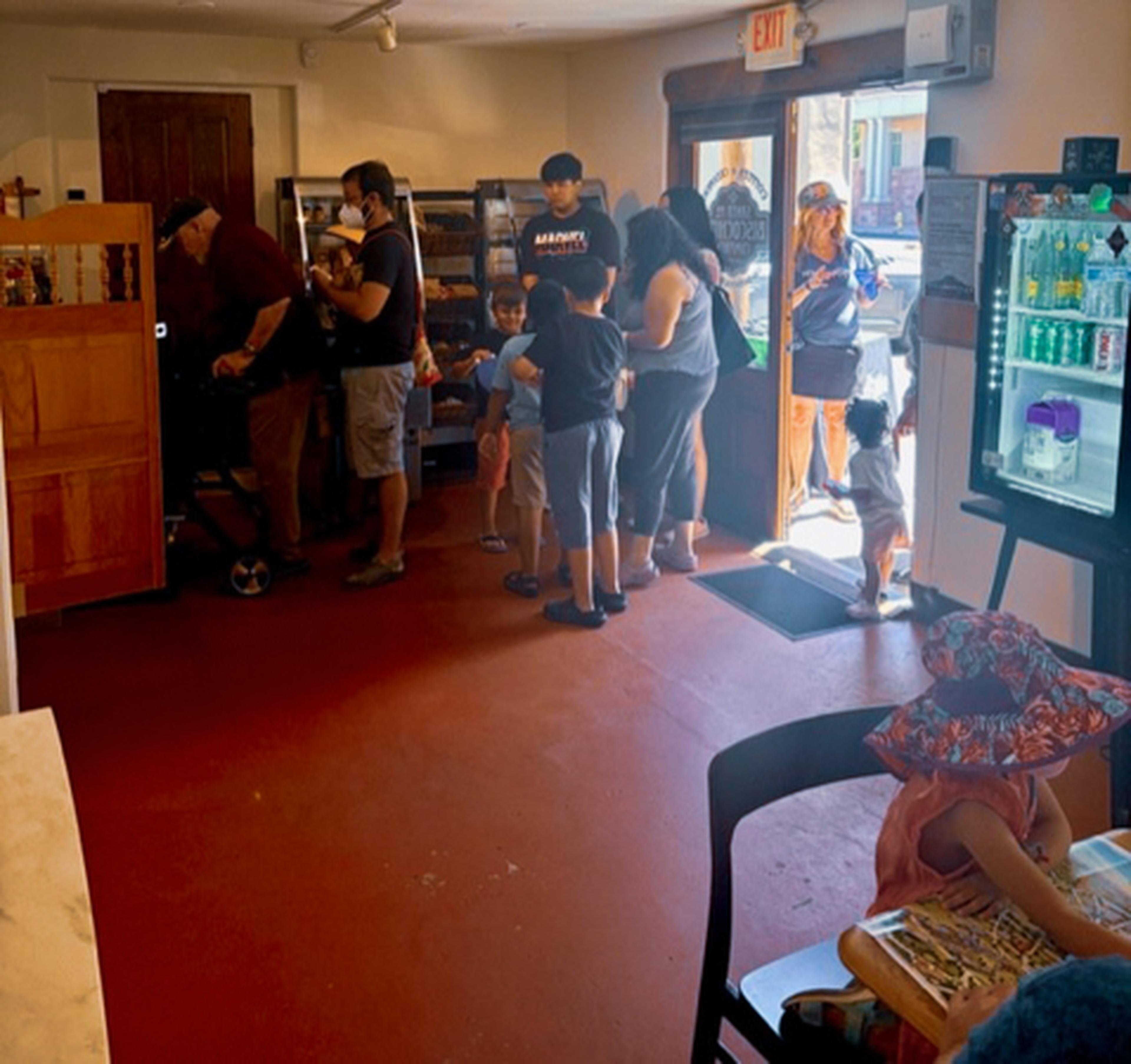 Indoor restaurant with a line of people going out the door