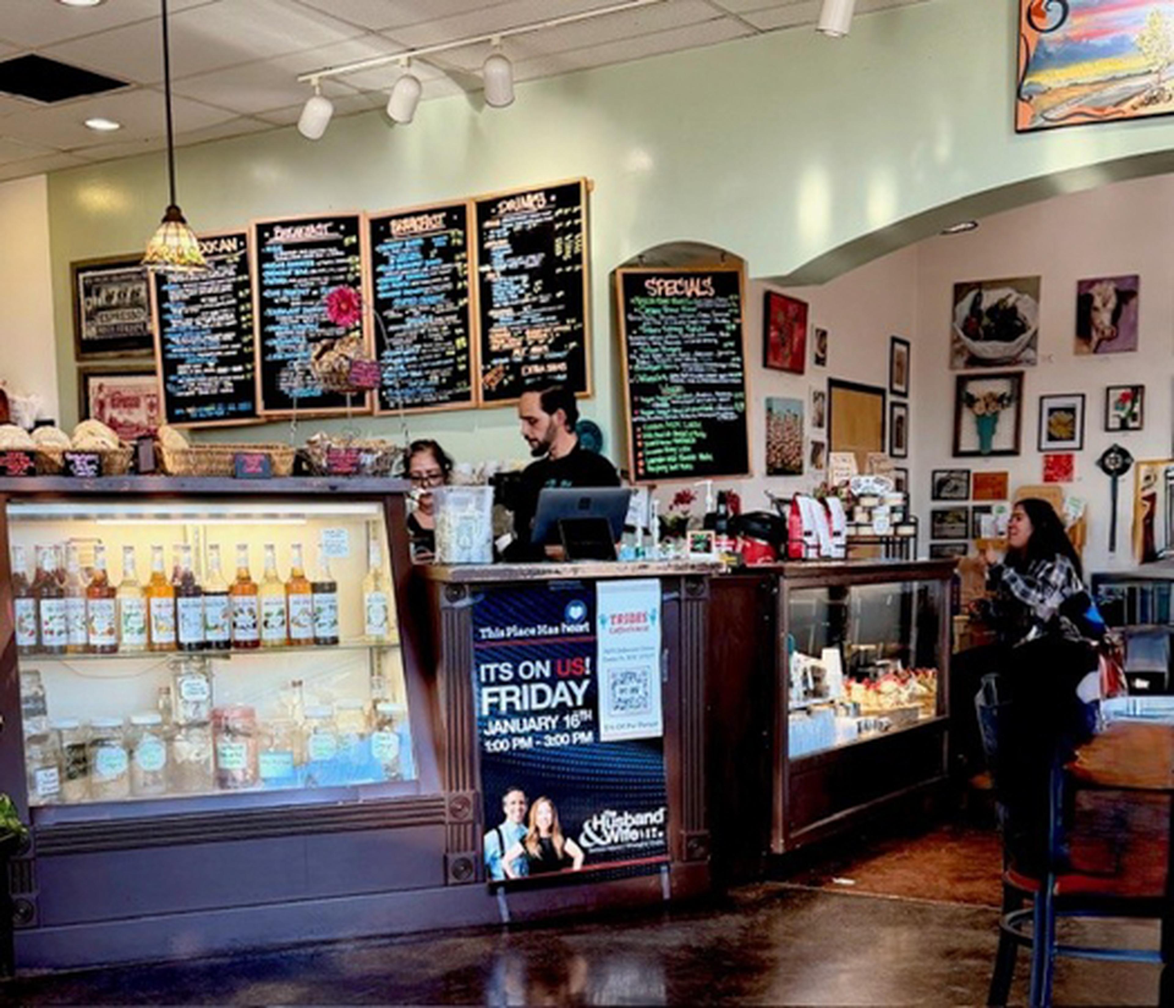 Tribes Coffeehouse interior with a menu board above a counter
