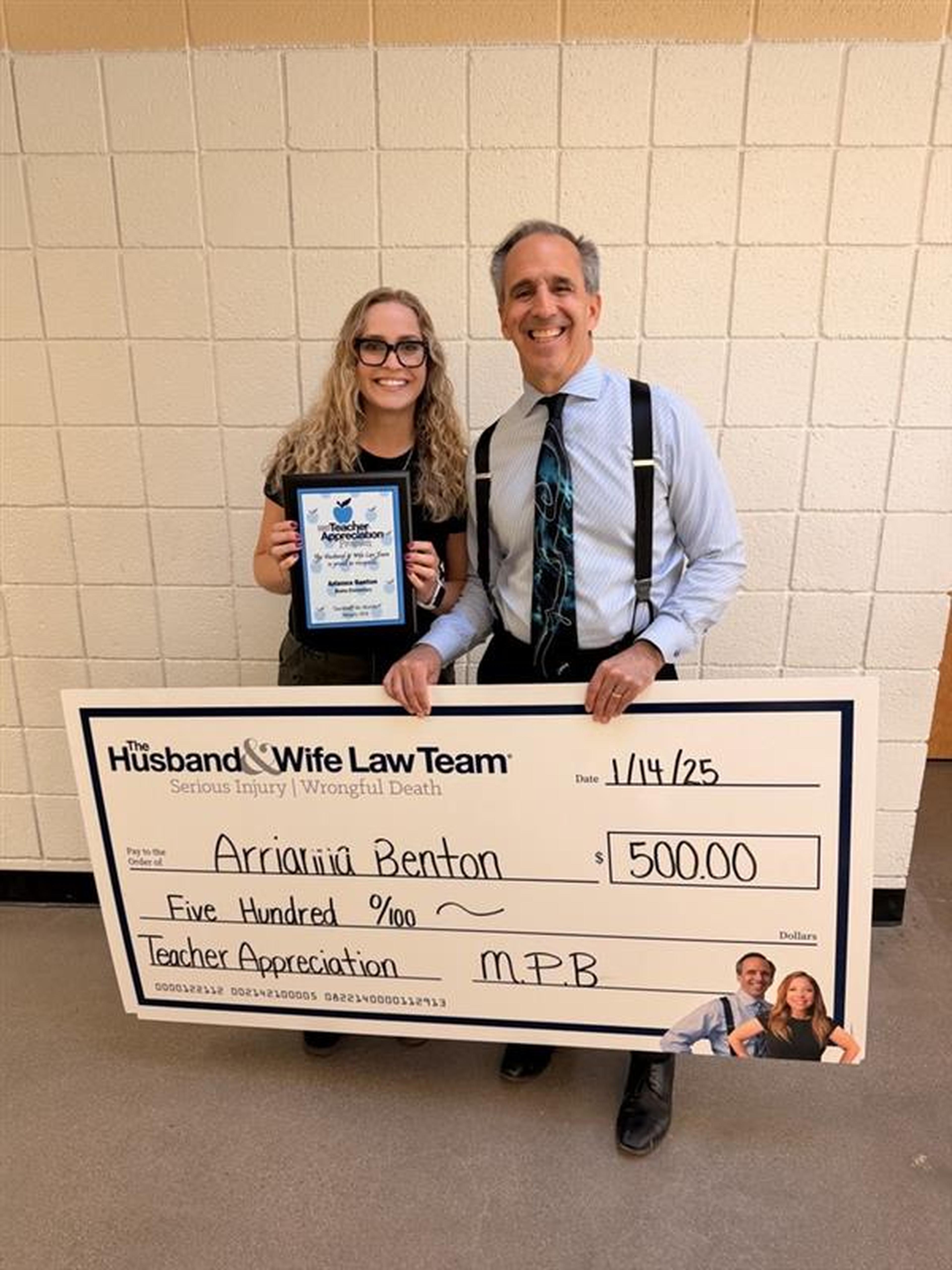 Mark Breyer and Mrs. Benton holding a large check for $500.