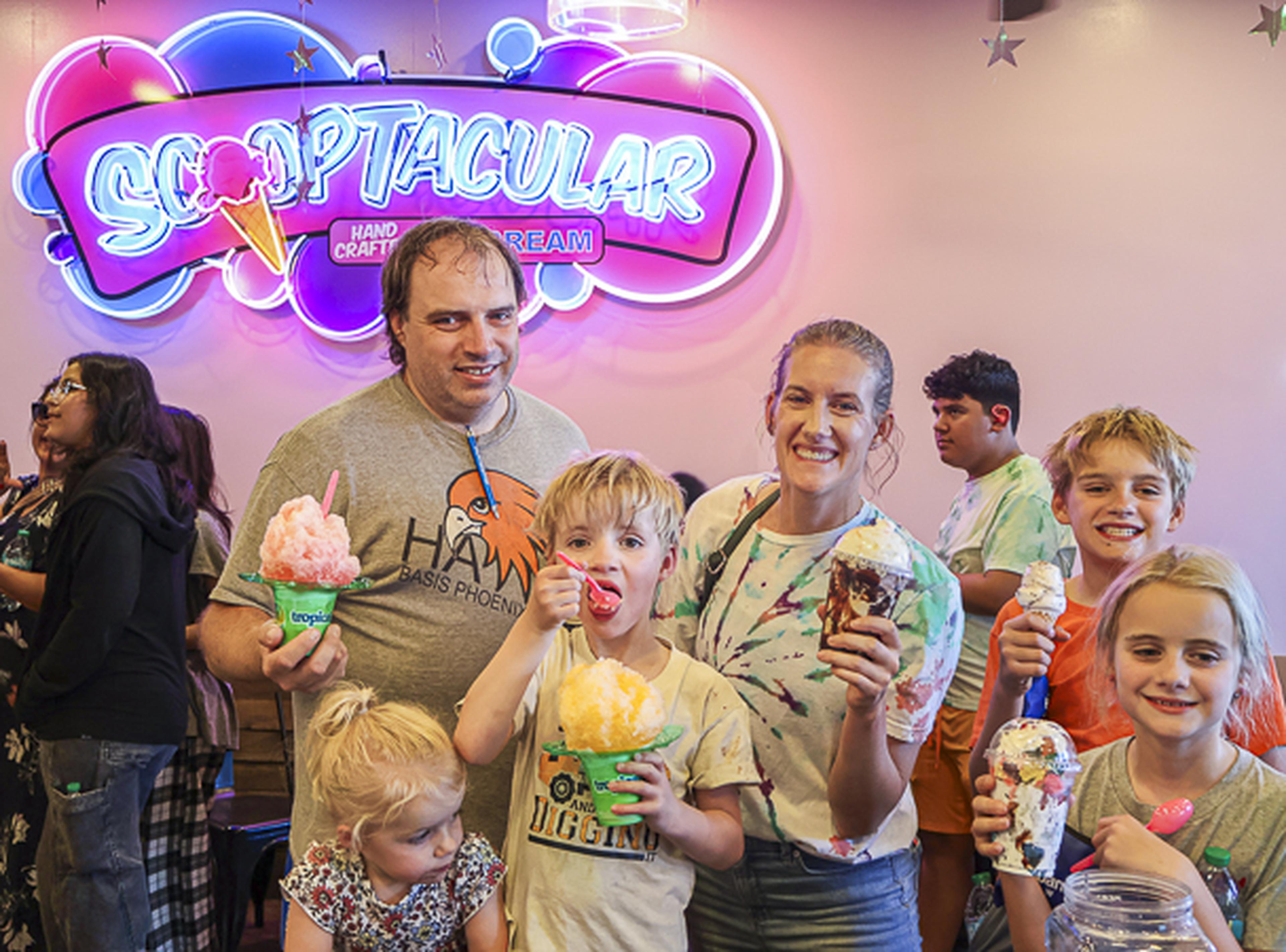 A family enjoys sweet treats together at the SCOOPTACULAR HEART Event, creating lasting memories while celebrating community and connection.