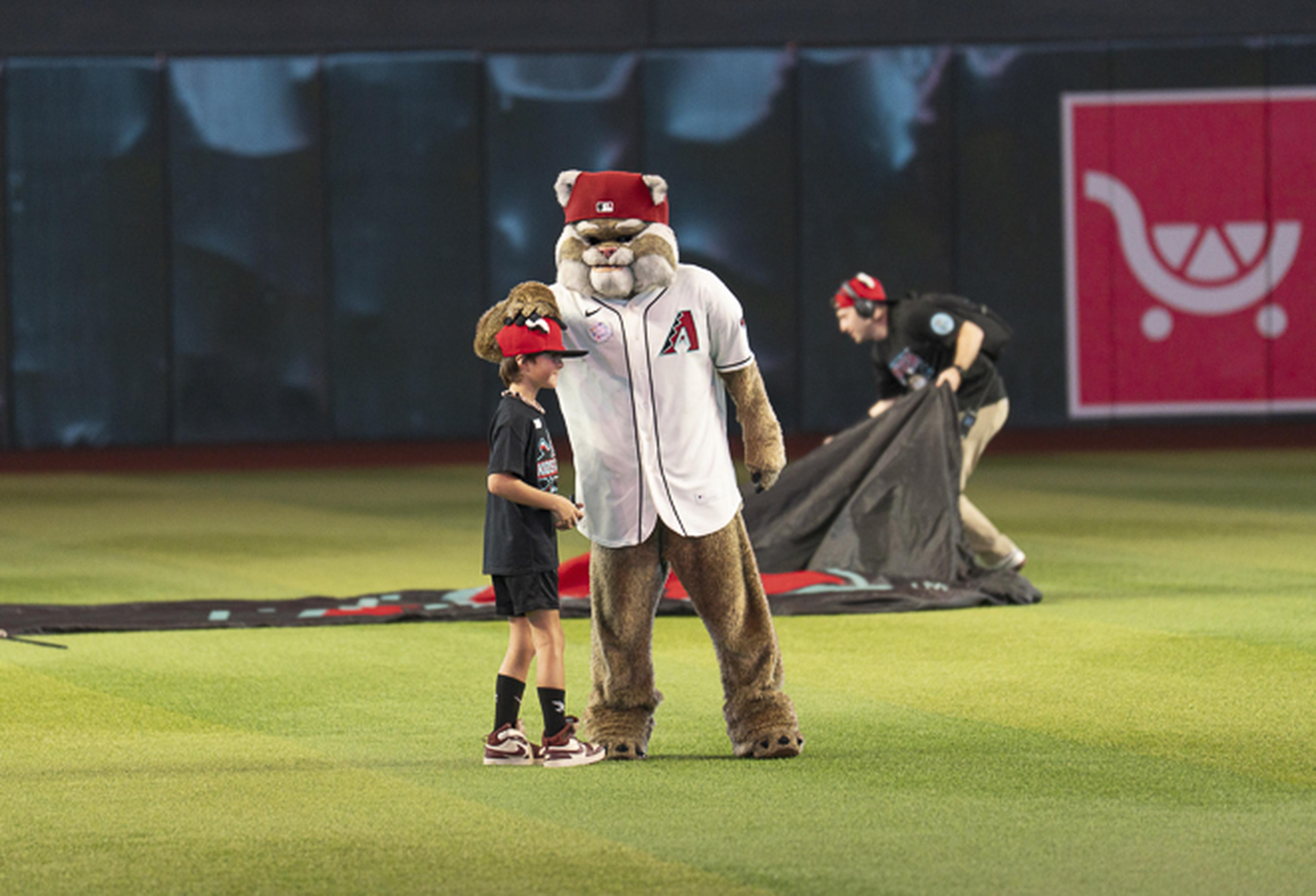 Baxter joins a young fan on Chase Field for a memorable Kids Take the Field moment before the game.
