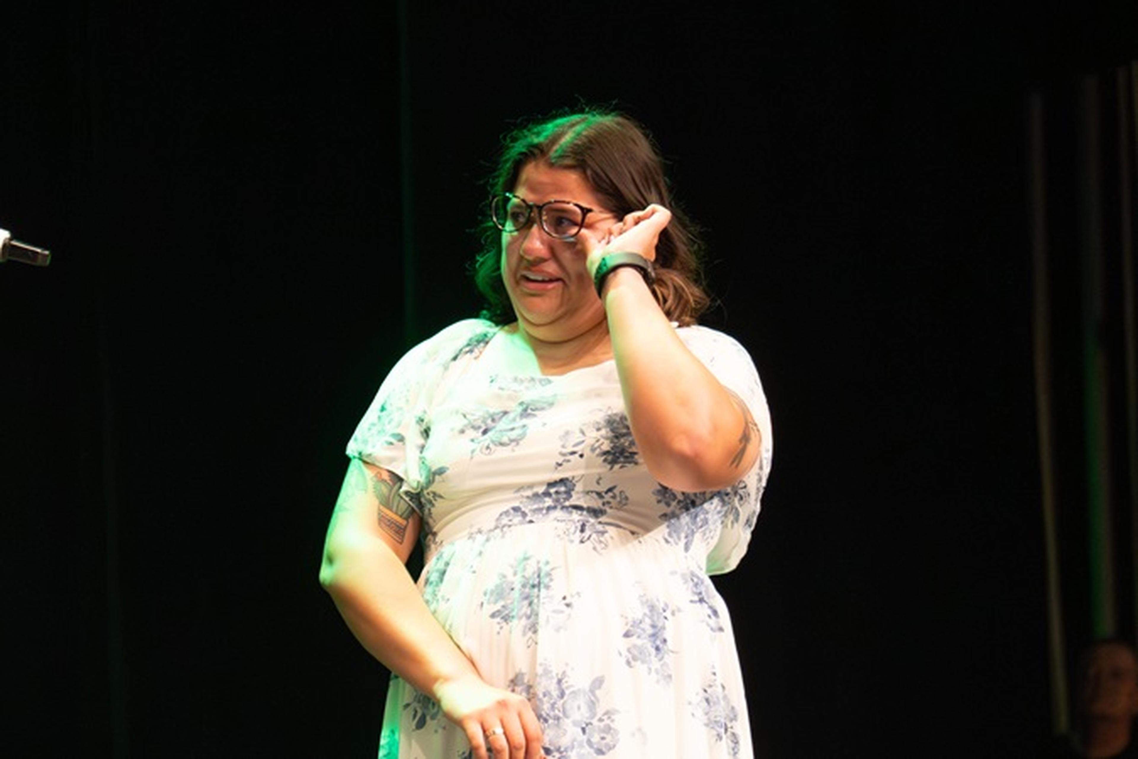 Ms. Johnson stands on stage, emotion shining through as she hears why she was chosen for the Teacher Appreciation Award.