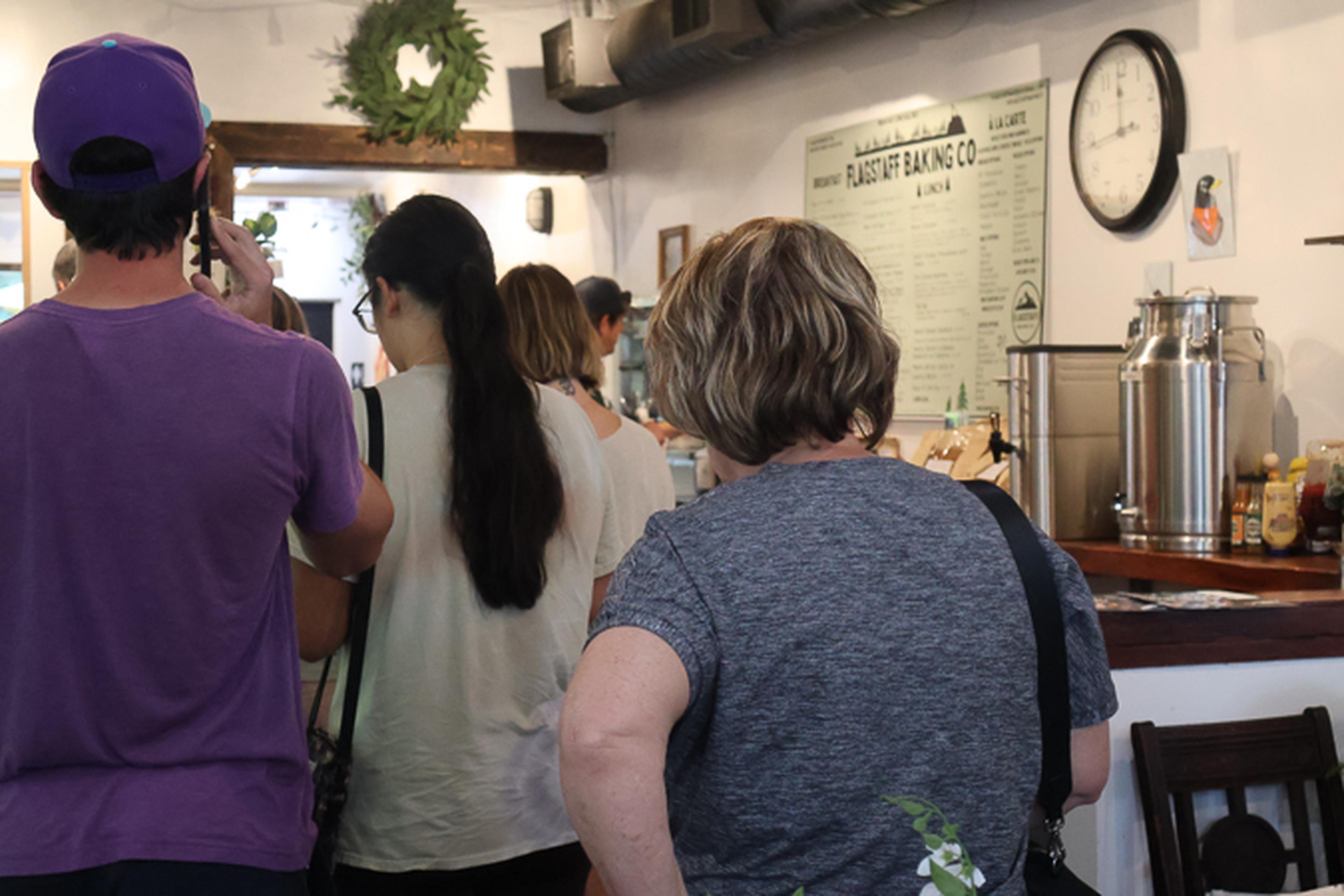 Guests line up inside Flagstaff Baking Co., creating a lively atmosphere as community members gather to enjoy the event and local favorites.