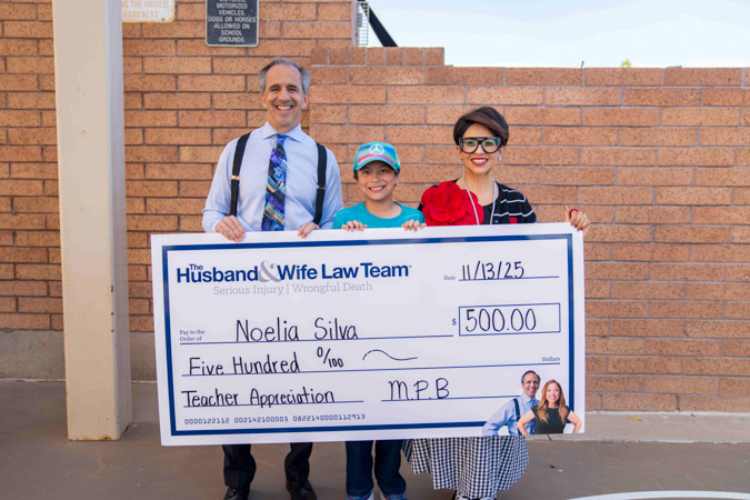 Mark presents Mrs. Silva with her Teacher of the Month check! A teacher, a student, and Mark Breyer stand together while holding an oversized check for $500 for the teacher