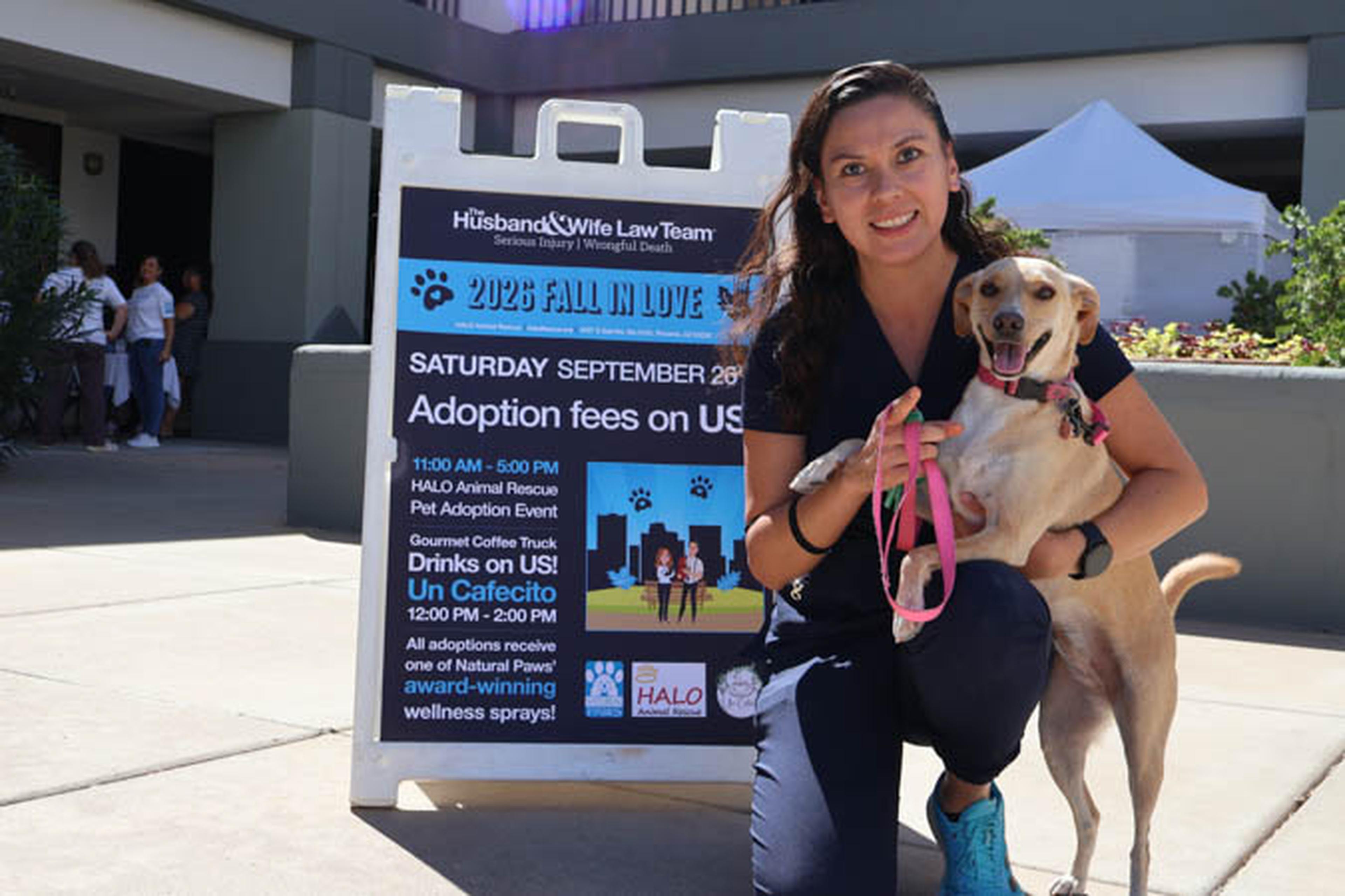 A happy adopter shares a special moment with her new four-legged companion at the Husband & Wife Law Team’s HALO Adoption Event, celebrating the start of a loving forever home.