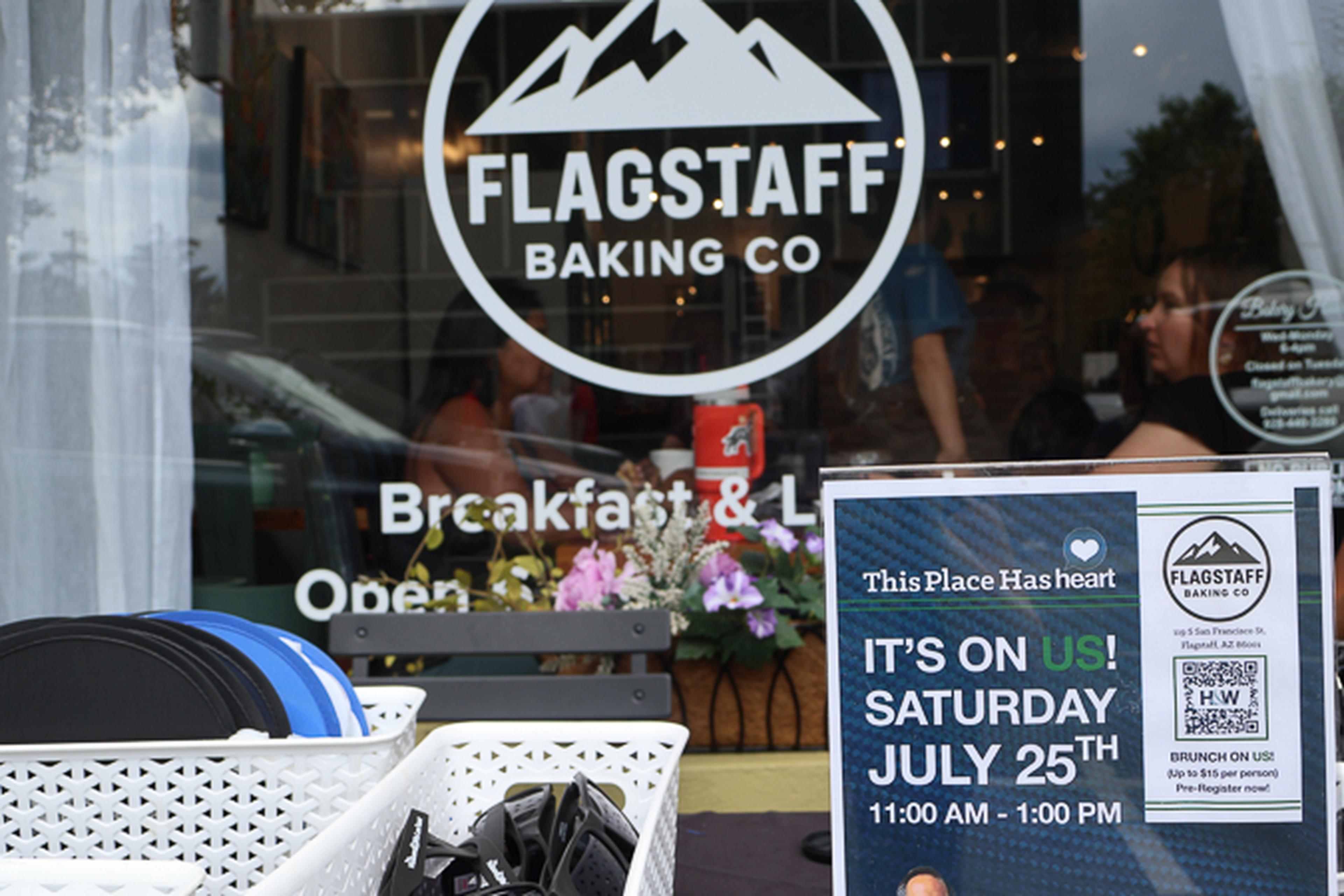 A welcoming view inside Flagstaff Baking Co. highlights a sign promoting a free brunch event, inviting community members to gather and connect.