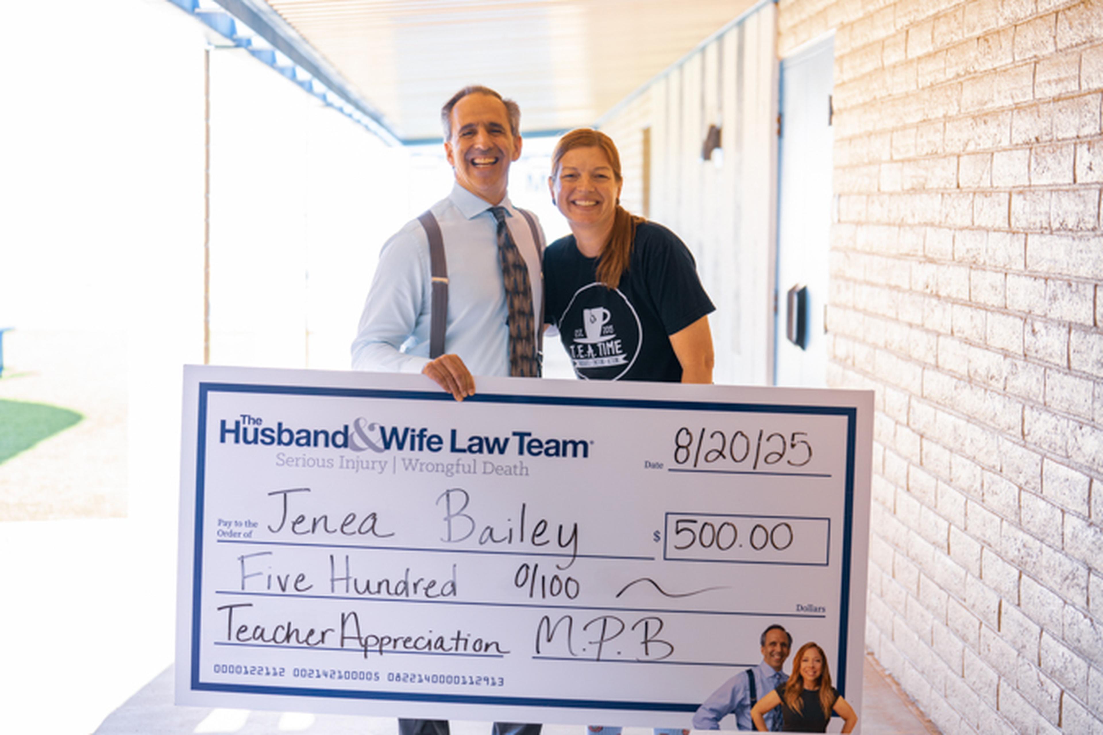 Mark Breyer poses with Mrs. Bailey and her oversized award check