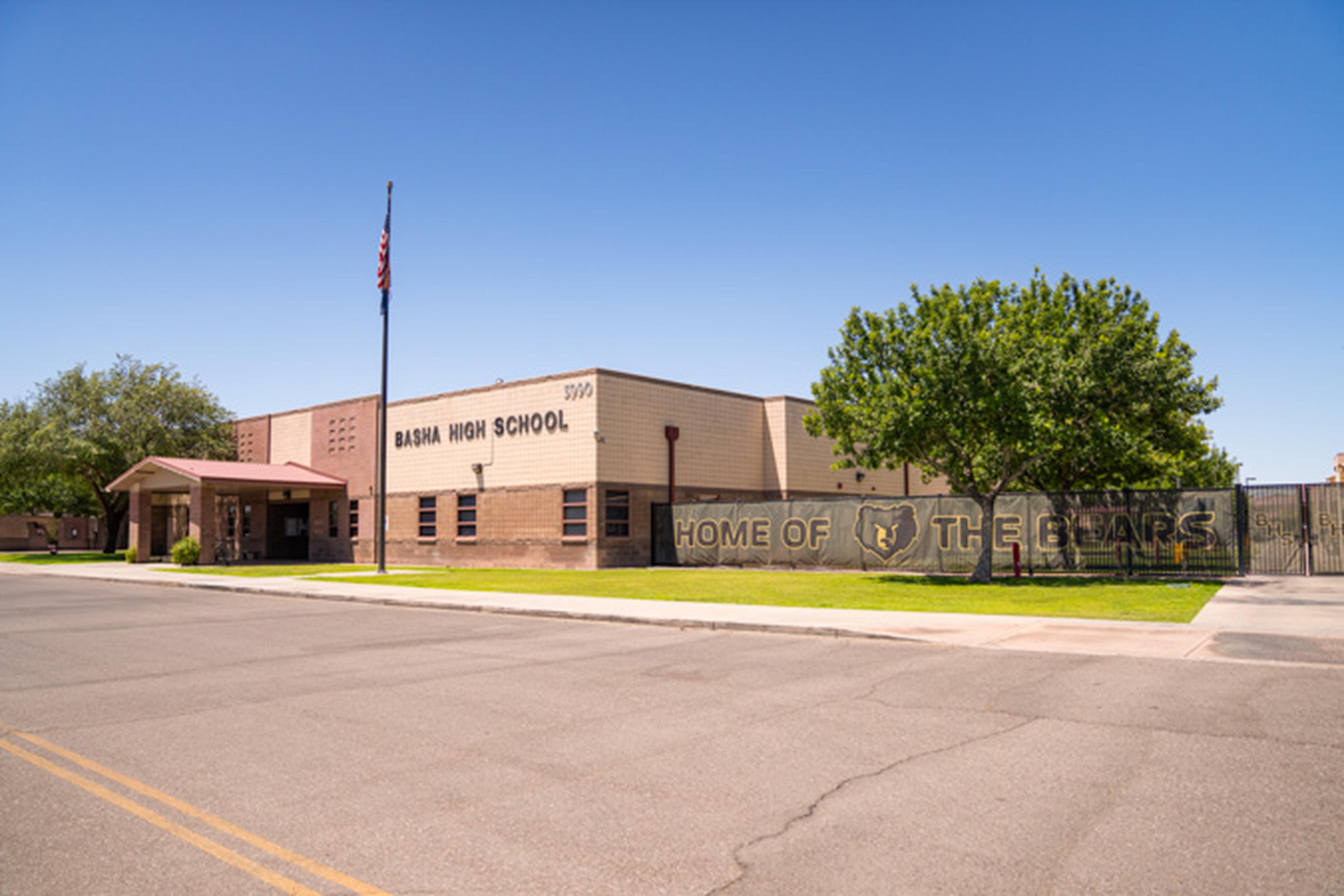 A picture‑perfect campus at Basha High School, featuring the American flag, surrounding trees, and the iconic “Home of the Bears” sign under clear skies.