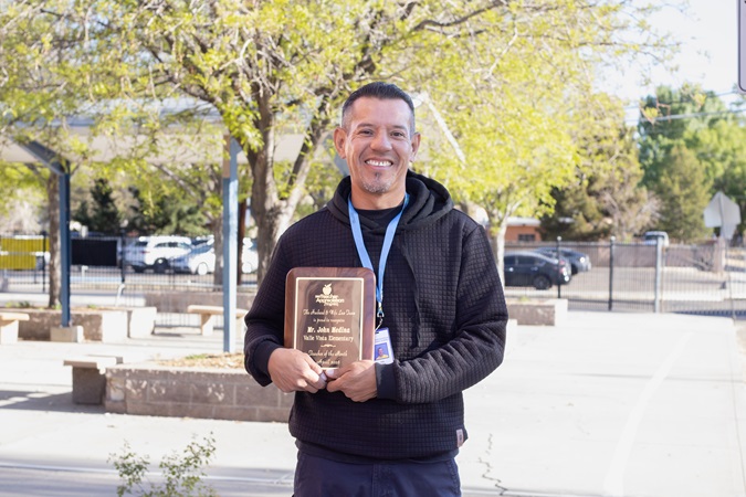 Mr. Medina beams with pride as he holds The Husband & Wife Law Team’s Teacher Appreciation Award outdoors. Mr. Medina proudly holds The Husband & Wife Law Team’s Teacher Appreciation Award outside.