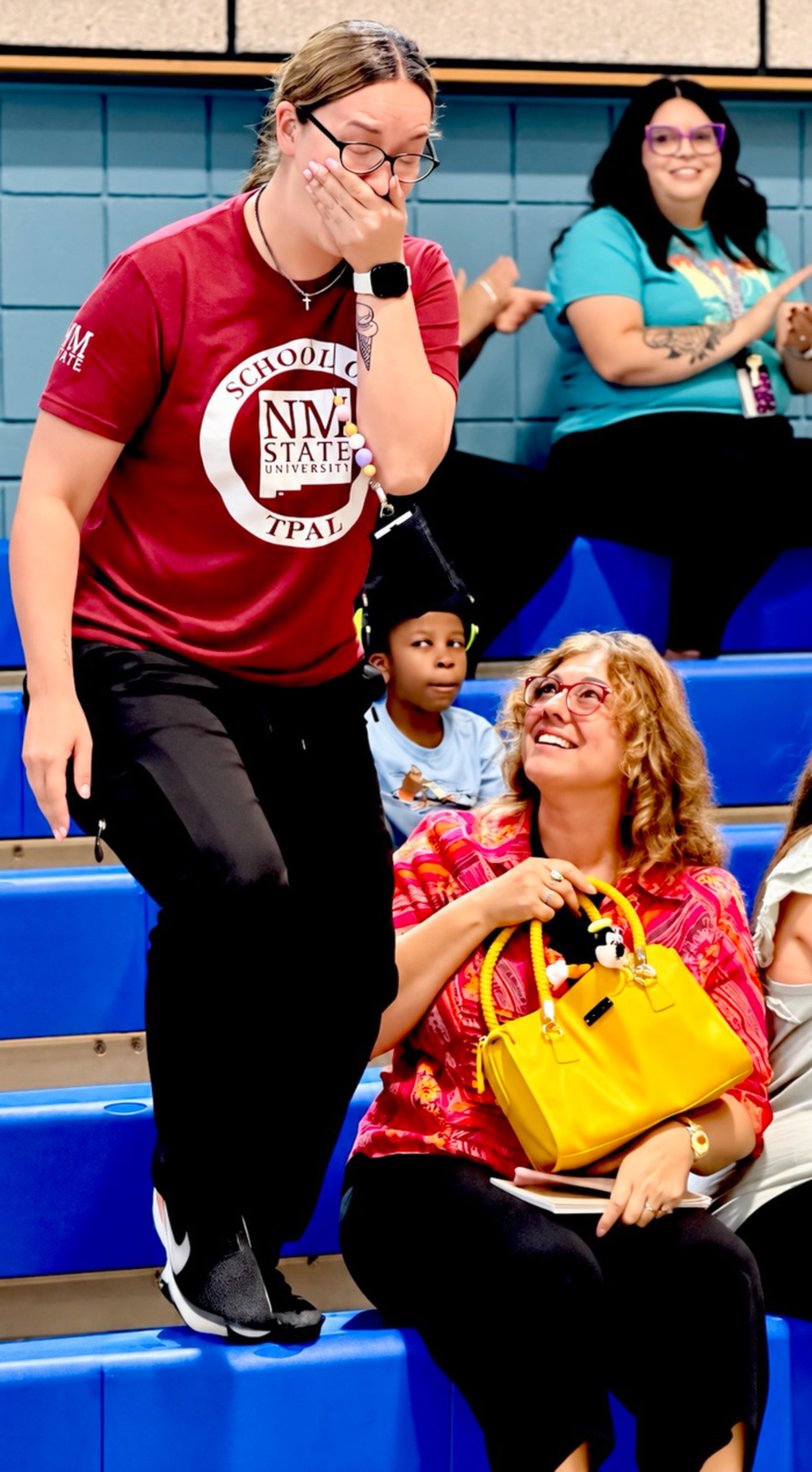 A surprised Ms. Quintana reacts to her Teacher Appreciation recognition, taking in the special moment as the celebration unfolds at Chaparral Elementary School.