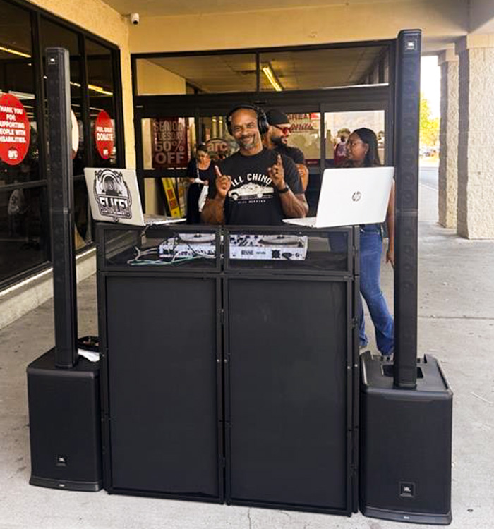 A DJ keeps the energy high at the Husband & Wife Law Team’s HEART event, providing music and entertainment as community members gather for a day of fun and connection.