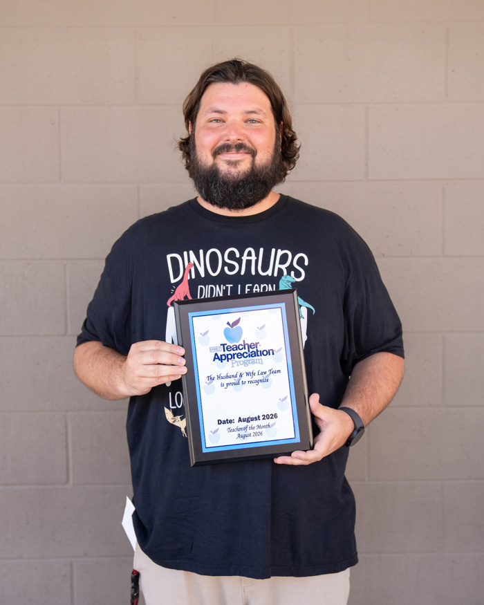 Mr. Knowles proudly displays his Teacher Appreciation Award, recognizing the positive impact he makes on students each day at Val Vista Academy.