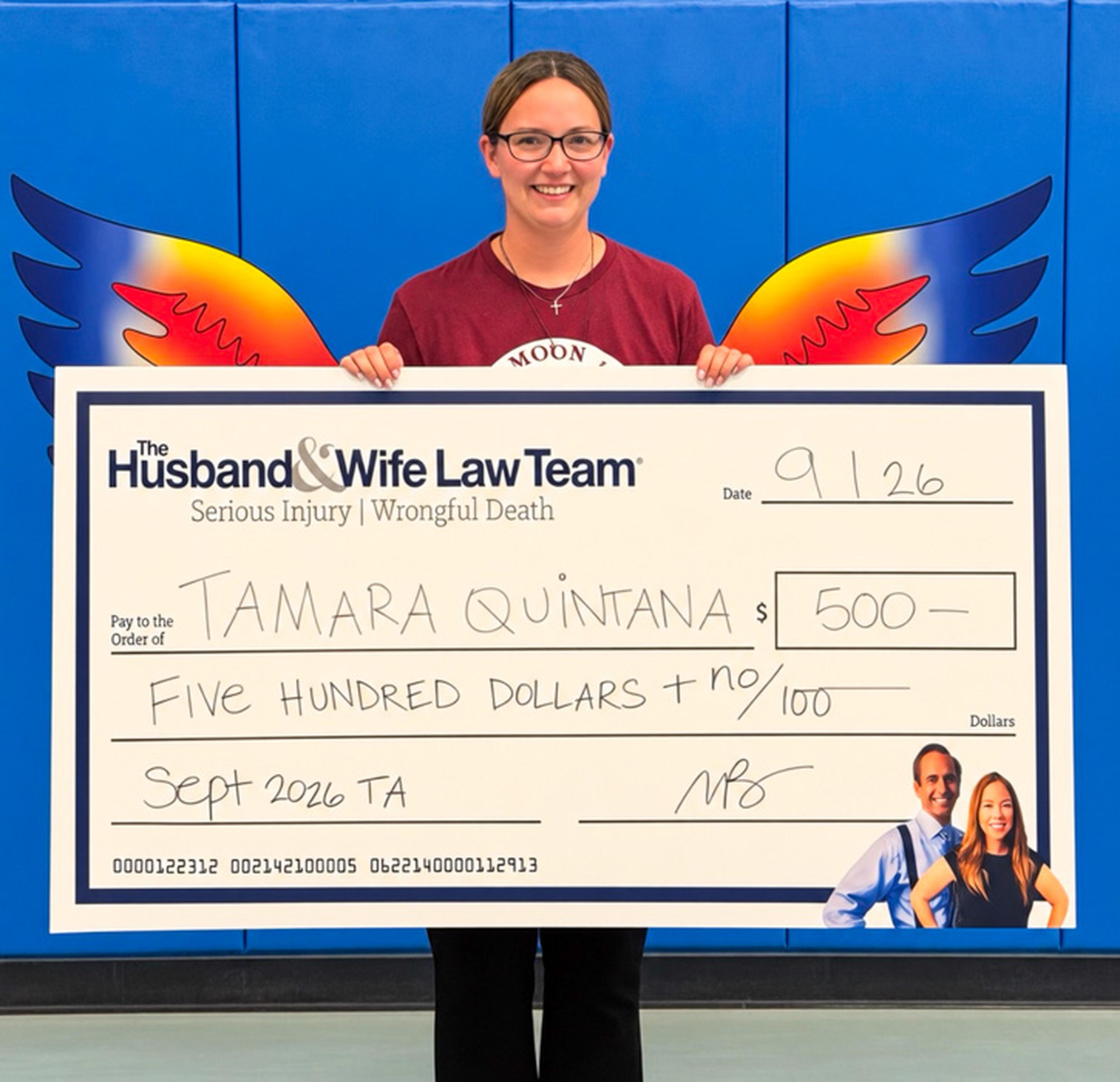 Ms. Quintana proudly displays her $500 Teacher Appreciation Award from the Husband & Wife Law Team, celebrating her outstanding dedication to the students of Chaparral Elementary School.