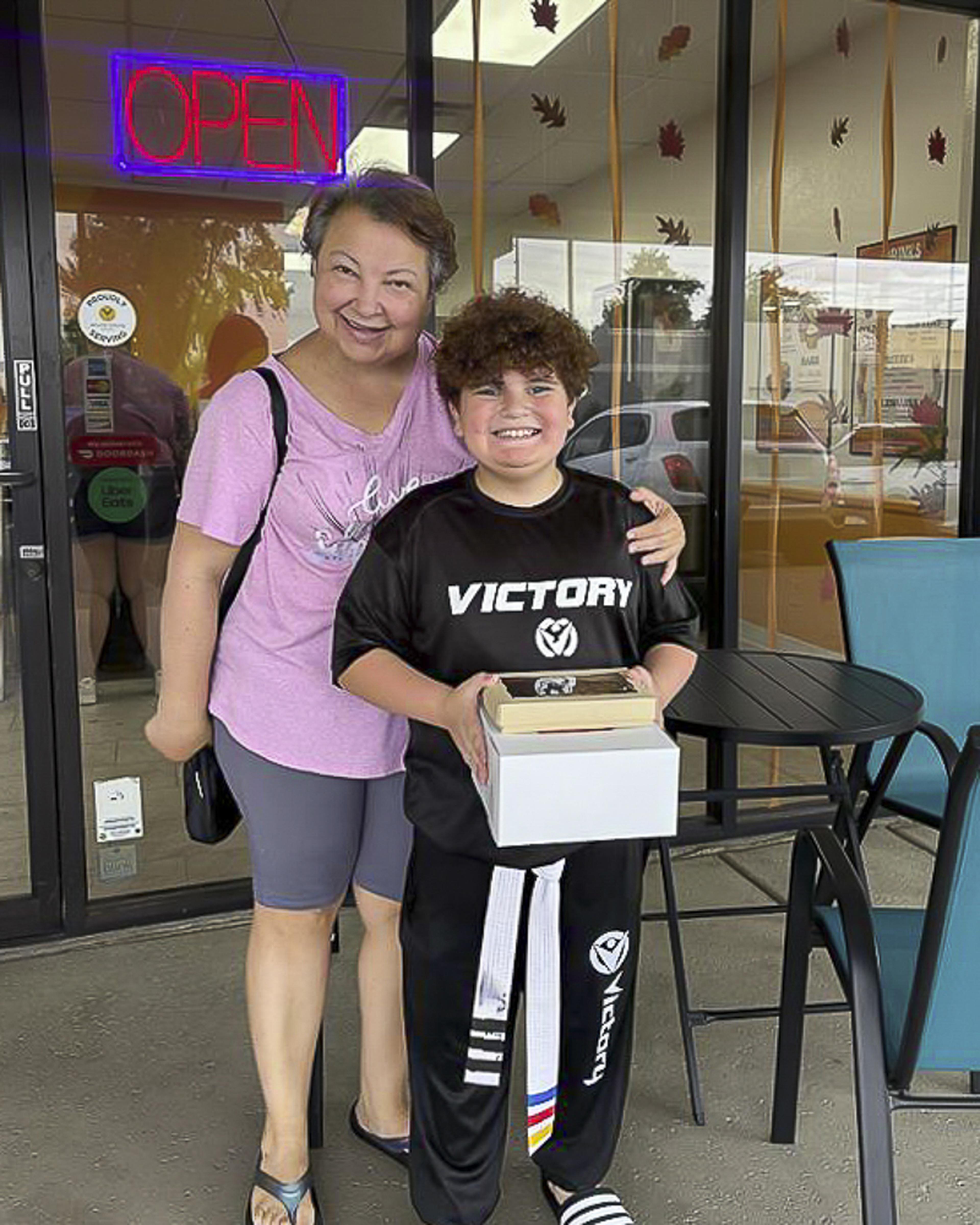 A smiling family enjoys sweet treats outside Besties Bakeshop during the Husband & Wife Law Team’s HEART event.