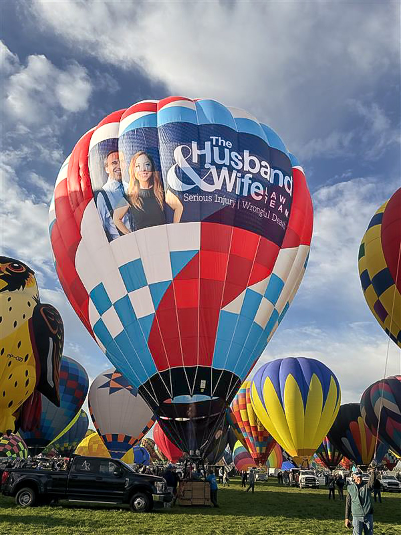 Ready to soar! The Husband & Wife Law Team balloon prepares for flight among a spectacular lineup of balloons in Albuquerque.