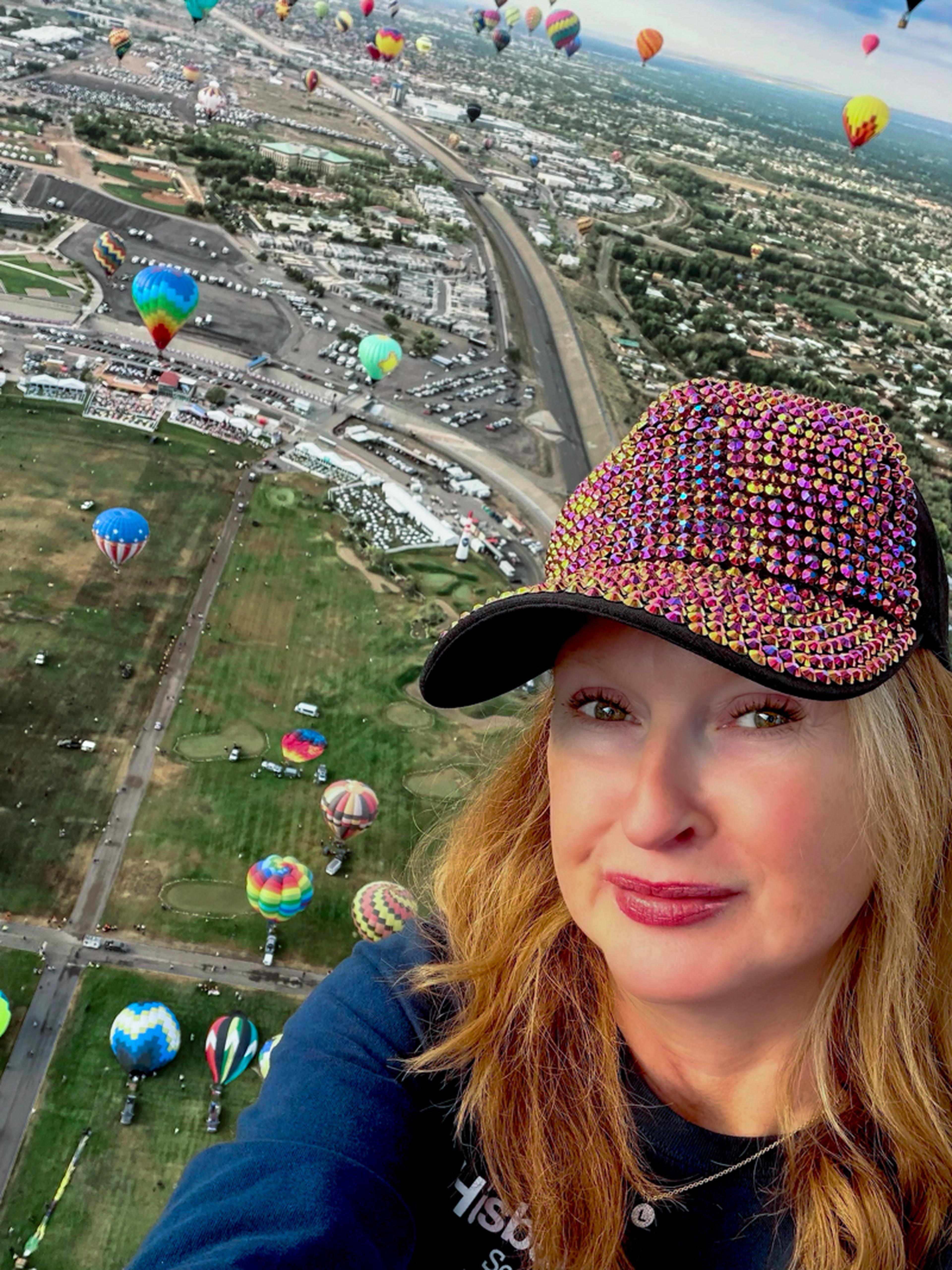 Lisa, one of the Husband & Wife Law Team’s New Mexico community ambassadors, takes in a breathtaking view high above the launch field at the Albuquerque International Balloon Fiesta.