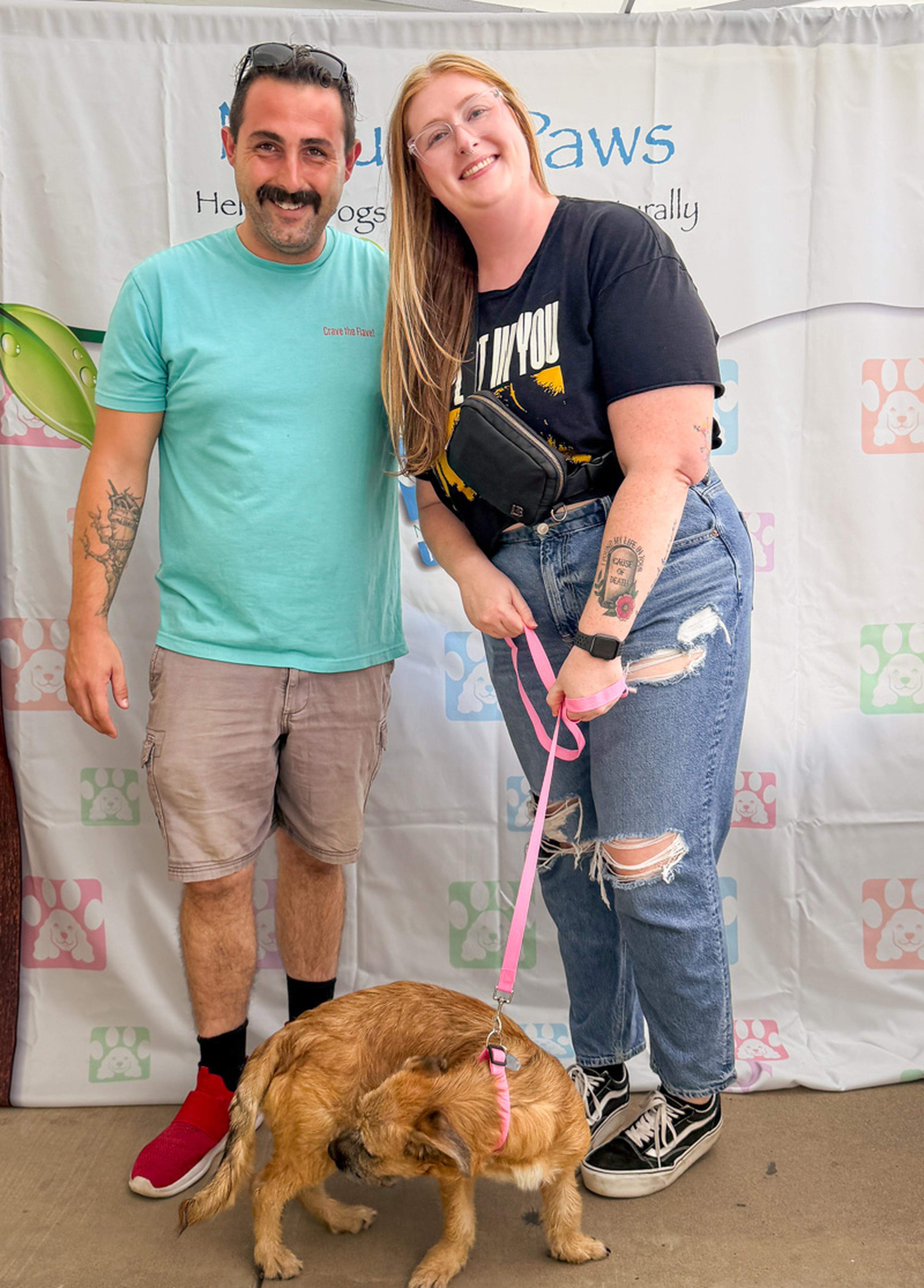 A happy couple poses with their new four-legged companion at the Husband & Wife Law Team’s HALO Adoption Event, celebrating the start of a wonderful new chapter together.