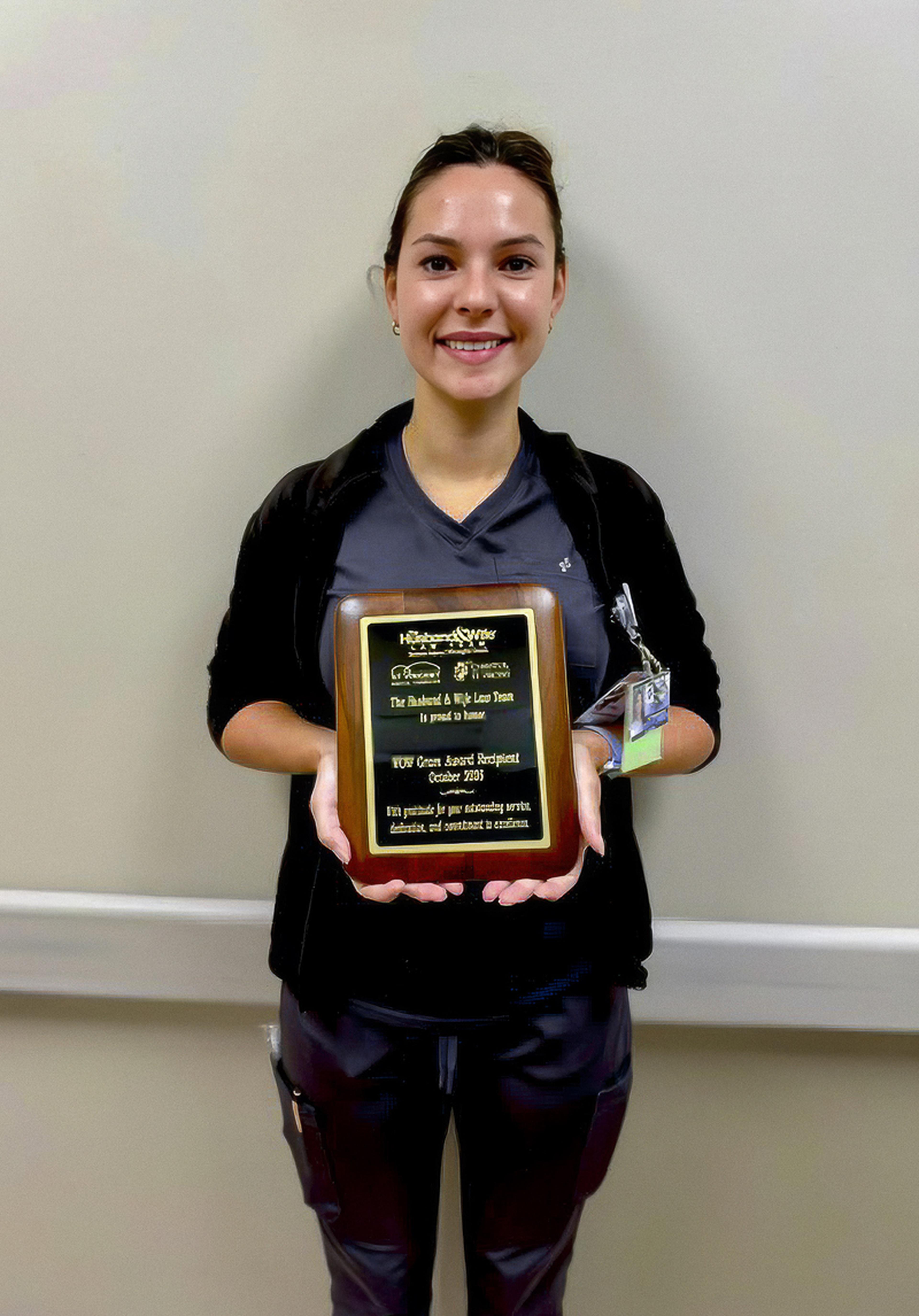 Nurse Cheyenne proudly displays her WOW Award, recognizing her dedication and outstanding contributions to healthcare in Santa Fe, New Mexico.