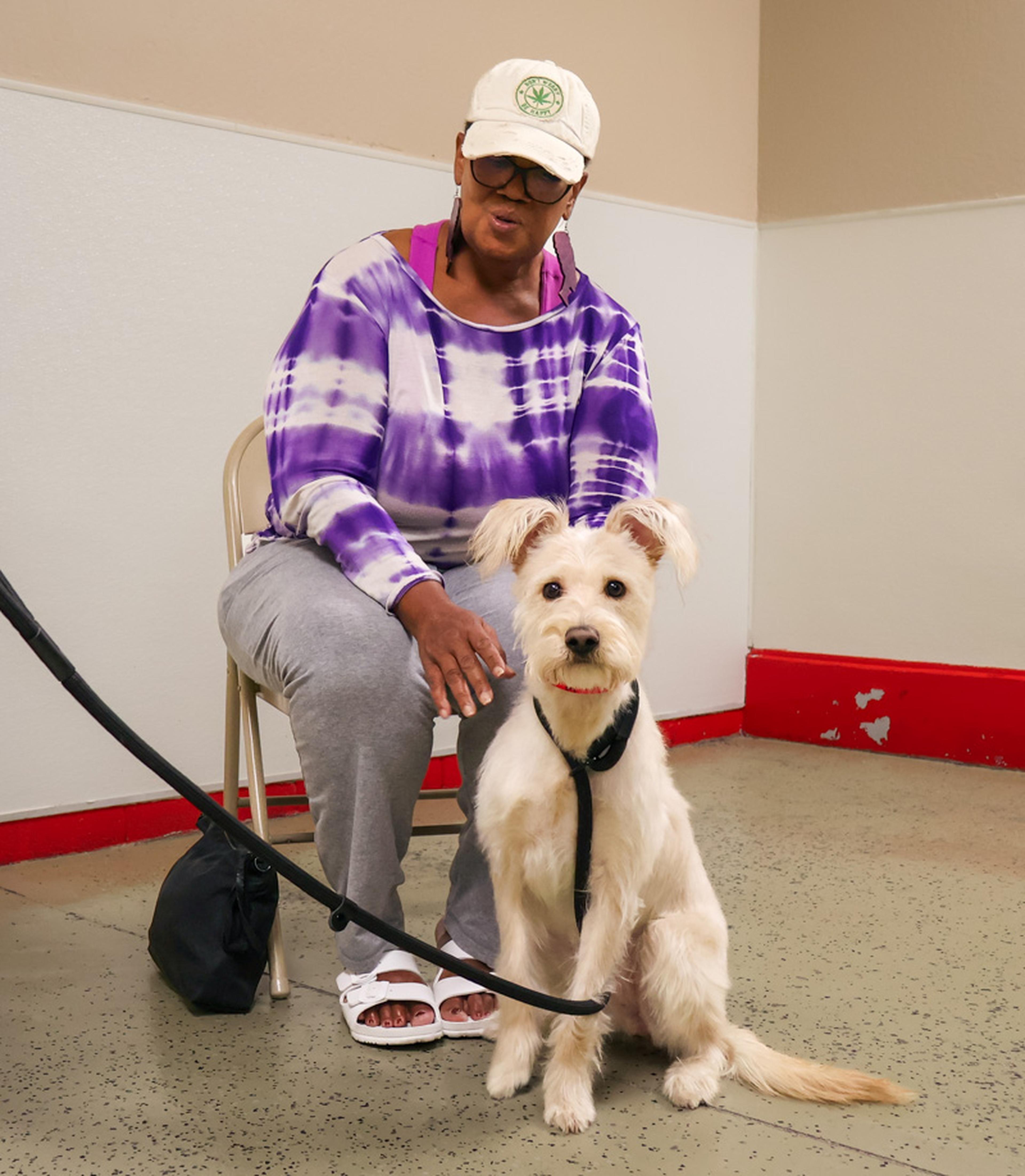 A special bond begins to form as an attendee spends time with an adoptable dog at HALO Animal Rescue during the Husband & Wife Law Team’s community adoption event.