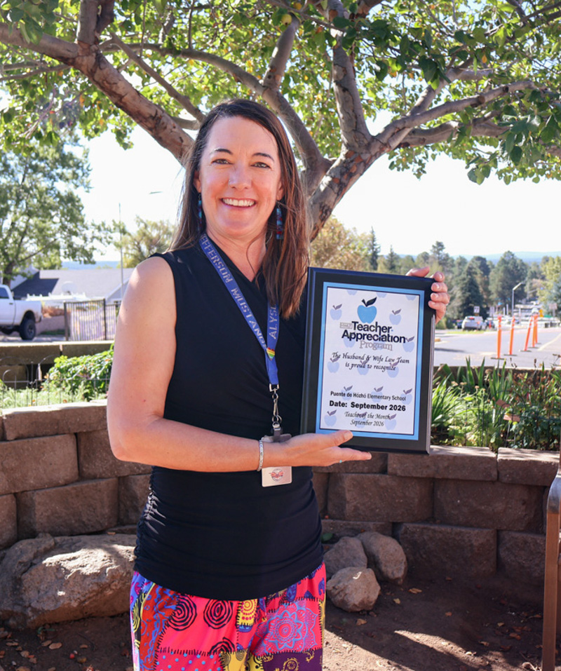 Honored for the difference she makes each day, Ms. Bottke smiles while holding her Teacher Appreciation Program certificate from the Husband & Wife Law Team, celebrating her commitment to student success and education. Ms. Bottke proudly displays her Teacher Appreciation Program certificate from the Husband & Wife Law Team, recognizing her dedication to creating a positive and inspiring learning environment for her students at Puente de Hózhó Elementary.