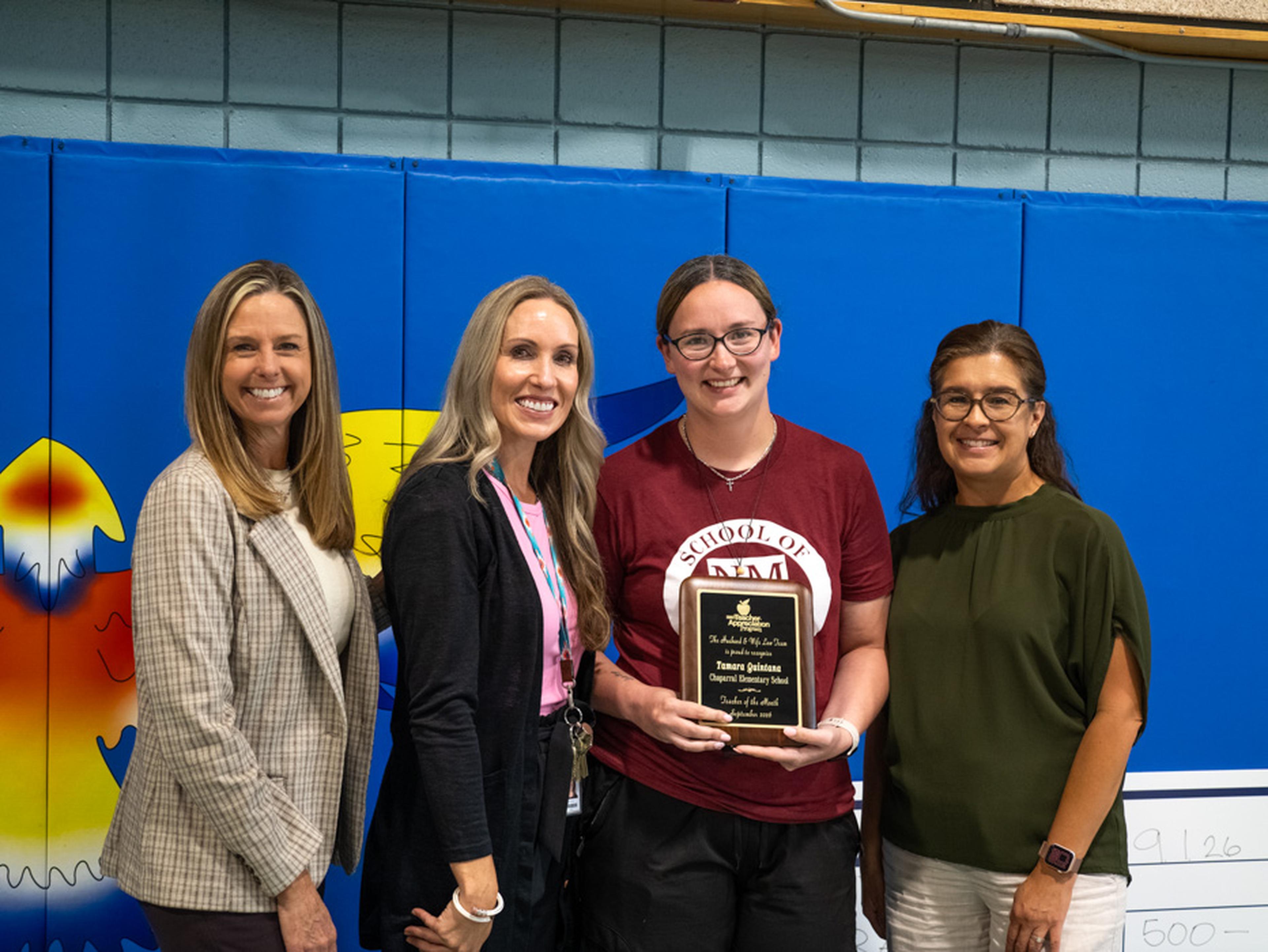 School staff gather to celebrate Ms. Quintana’s Teacher Appreciation Award, recognizing her dedication, leadership, and positive impact on students and colleagues.