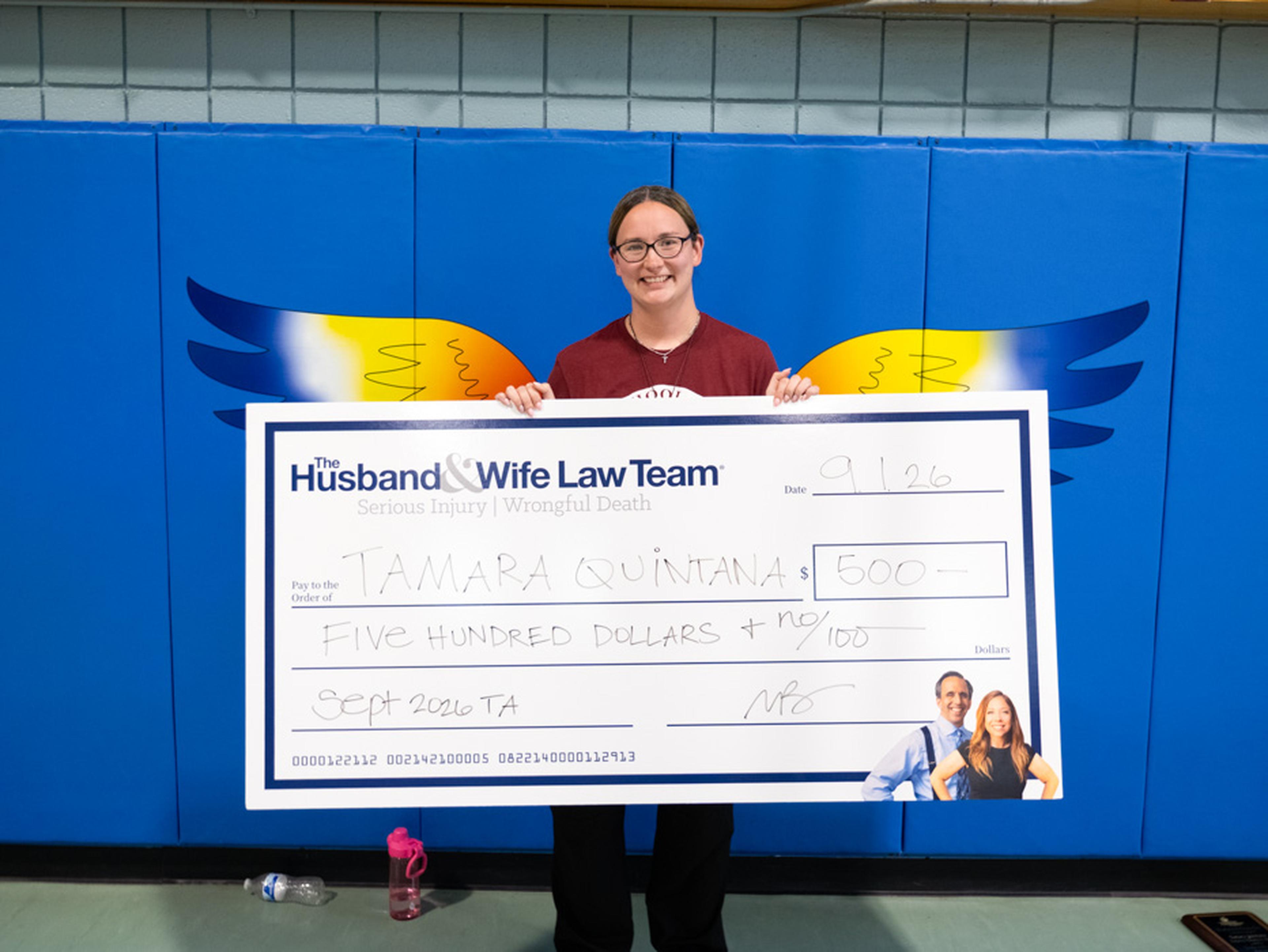 Ms. Quintana proudly displays her $500 Teacher Appreciation Award from the Husband & Wife Law Team, recognizing her dedication and positive impact on students at Chaparral Elementary School.